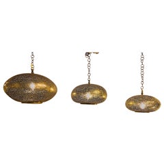 Set of Three Oval Shaped Brass Pendant Chandeliers in Graduating Sizes