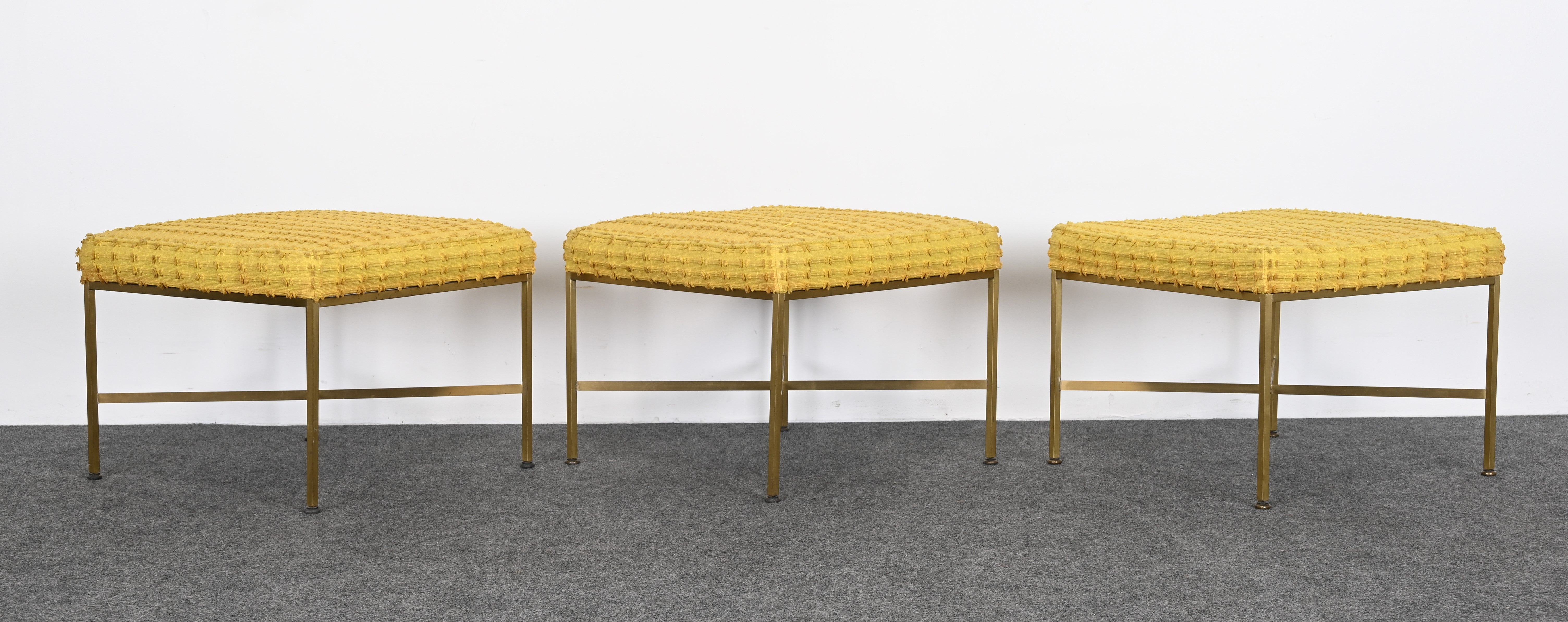 An elegant set of three brass benches with upholstery by Mid-Century designer Paul McCobb, circa 1950s. These benches are both versatile and functional and have a very minimalist design that would be great in any interior. They could be used in a