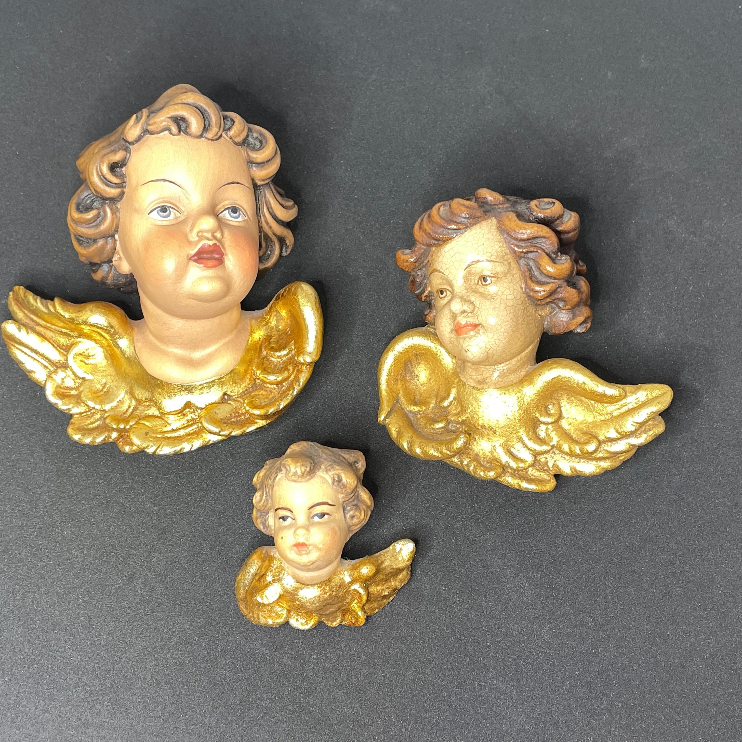 A set of three beautiful small miniature hand carved cherub angel Heads, found at an estate sale in Germany. Made by a woodcarver in the Oberstdorf in Germany, this area is well-known for their wood carvings. The size given in the dimensions section