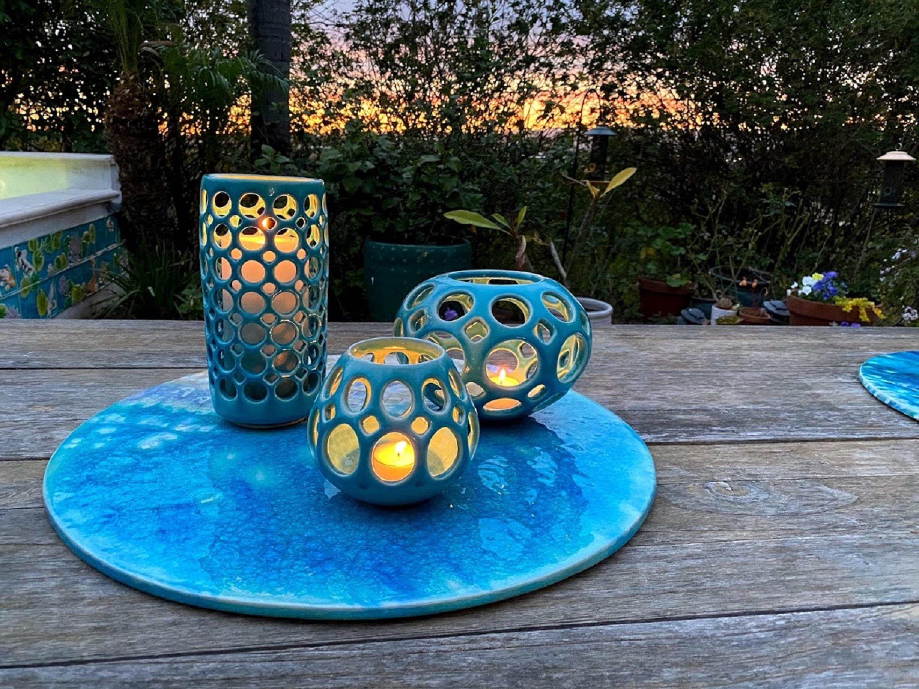 Inspired by Mid-Century Modern design, the pierced collection is wheel thrown and hand pierced stoneware with a turquoise crackle glaze. Small holes are created when the clay is still wet and then each hole is painstakingly enlarged and smoothed
