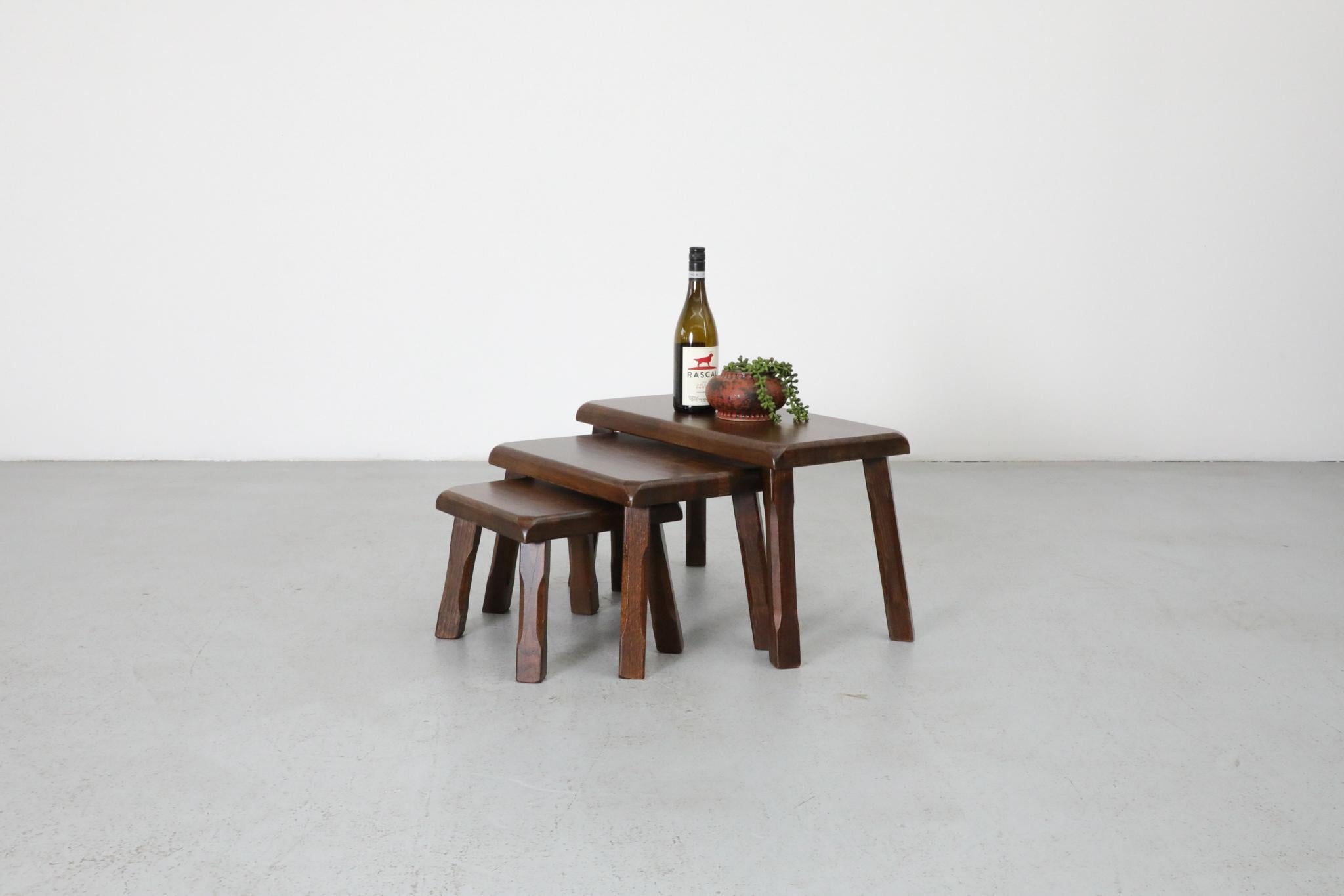 Set of 3 brutalist oak nesting tables inspired by Pierre Chapo with beautiful grain and carved detail on the legs. Perfect little side table, plant stand or small stool. (Not recommended for full adult weight). Lightly refinished with some remaining