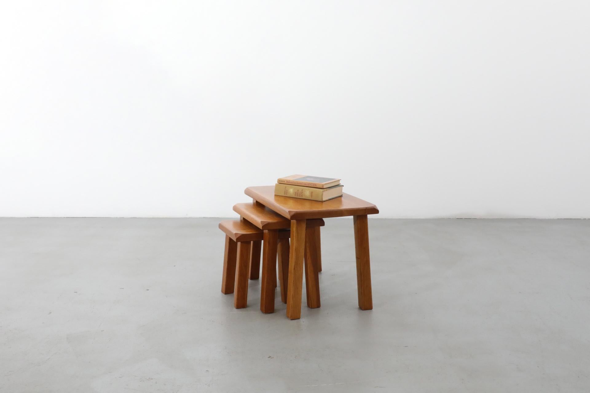 Set of 3 golden oak Pierre Chapo inspired Brutalist nesting tables with square legs and beveled corners. Large table is 21.25 x 13.25 x 15