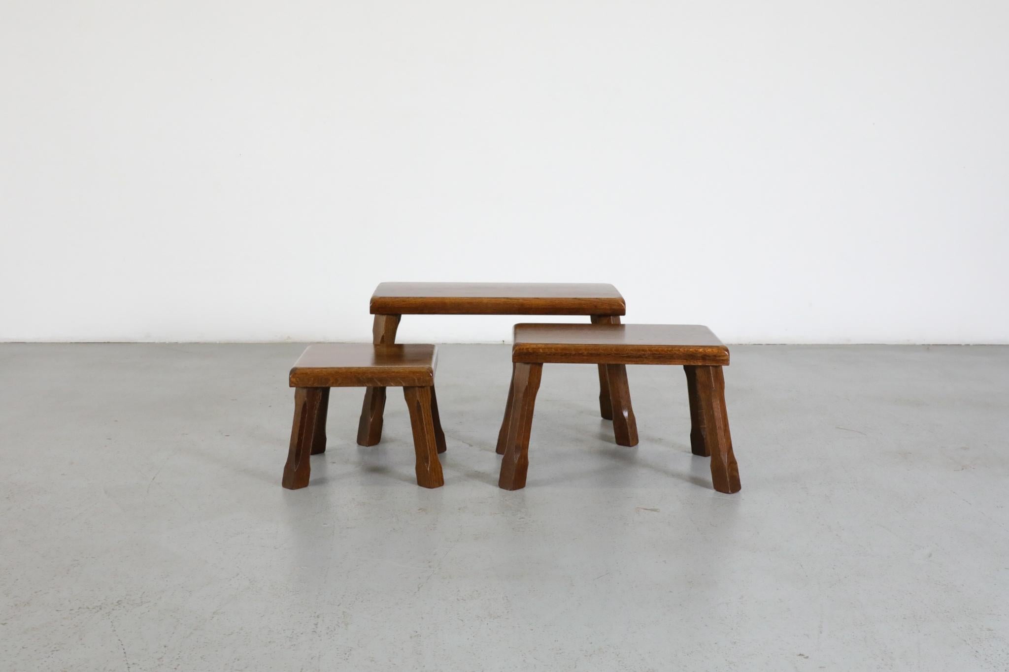 Set of 3 Pierre Chapo inspired Brutalist oak nesting tables with rounded edges and carved legs. Lightly refinished, in otherwise original condition with wear and some scratching consistent with age and use. Set price. Large table measures: 23.5