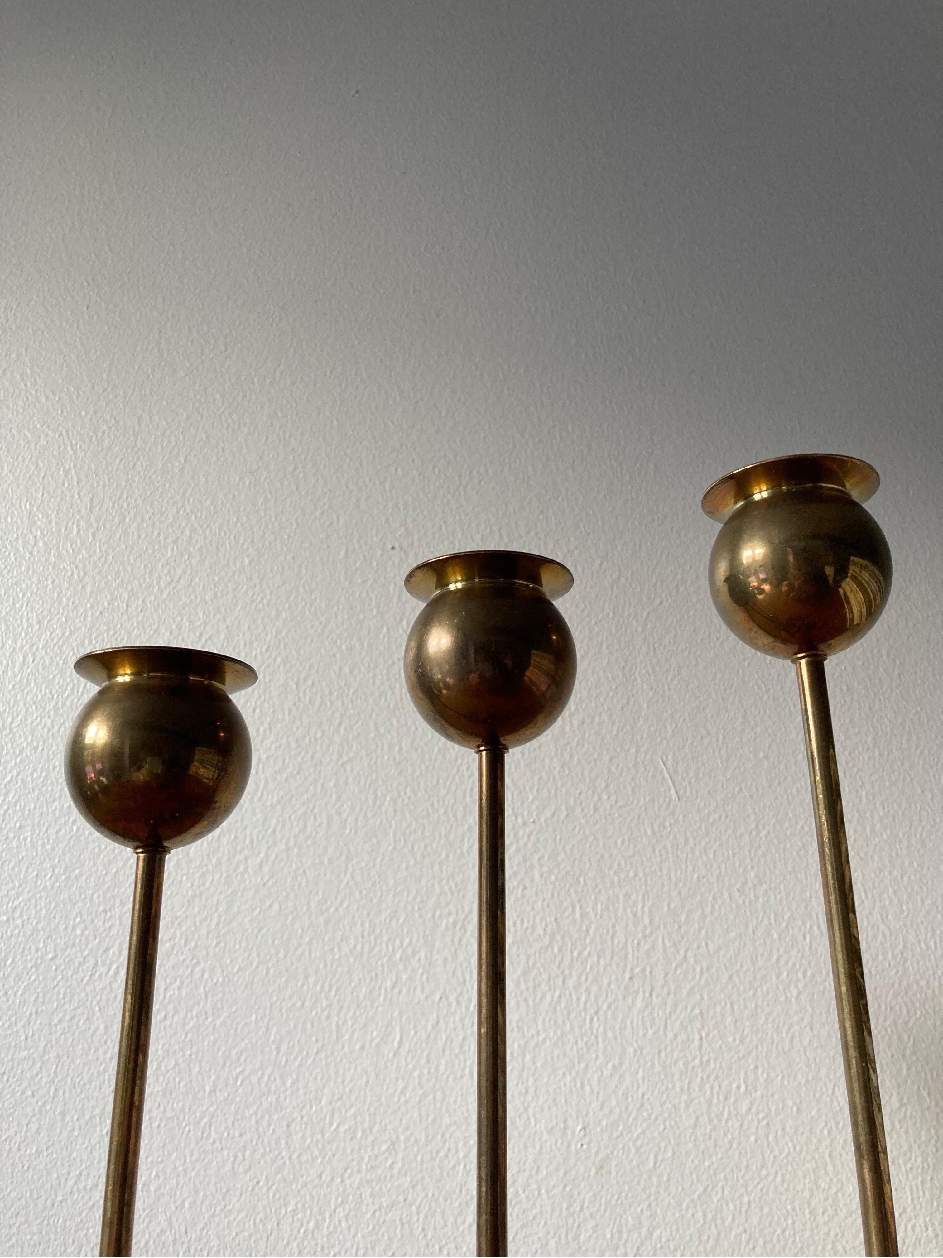 Satz von drei Pierre Forssell Tulpen-Kerzenhaltern aus Messing, hergestellt von Skultuna in den 1960er Jahren.

Die Kerzenhalter sind aus massivem Messing gefertigt und haben eine schöne natürliche Patina.
 