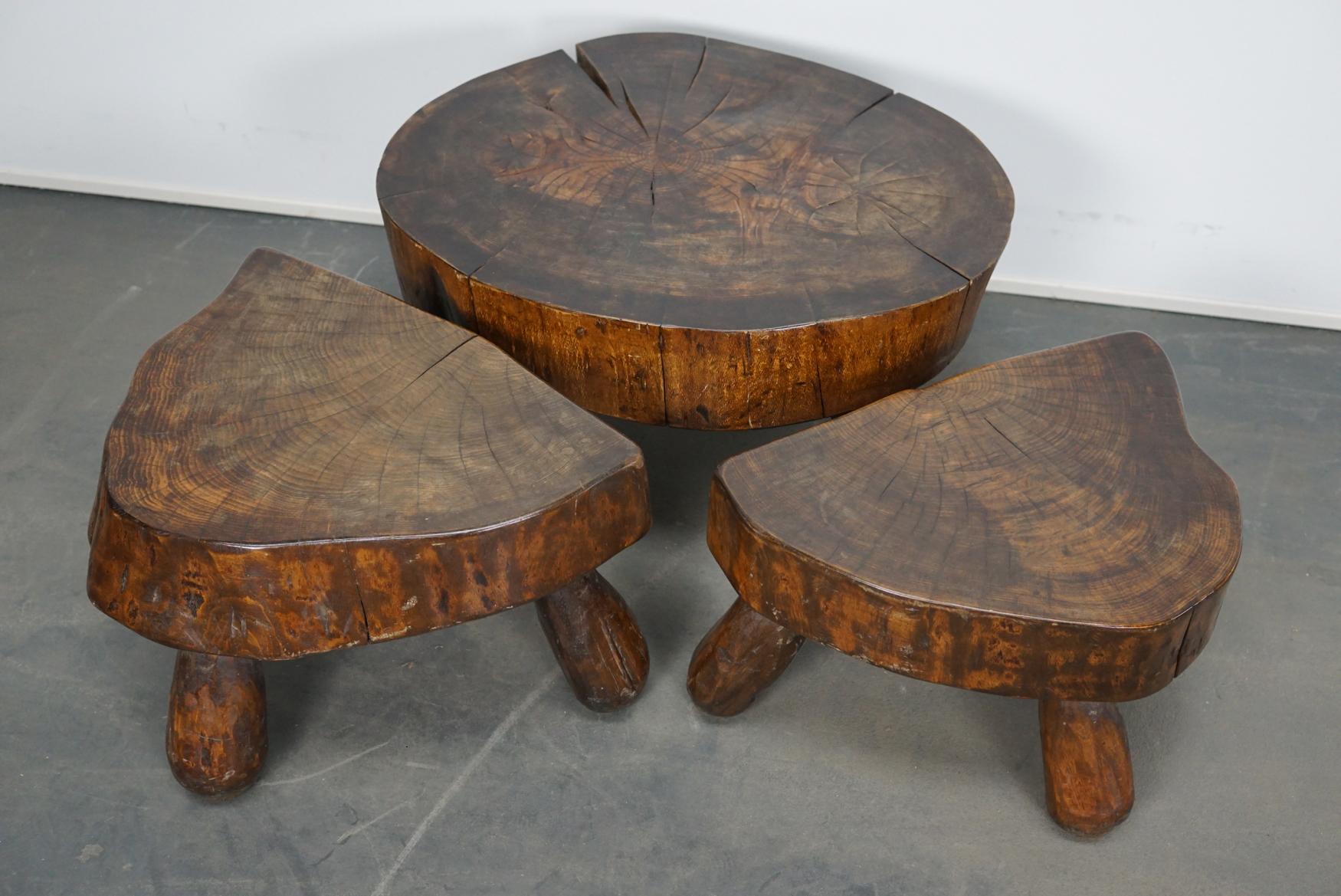 Amazing set of three polished walnut coffee tables. They were made circa 1970s in France from logs of a very old walnut tree. These decorative tables have retained a rich patina over the years. The measurements are: large table DWH 53 x 67 x 37 cm