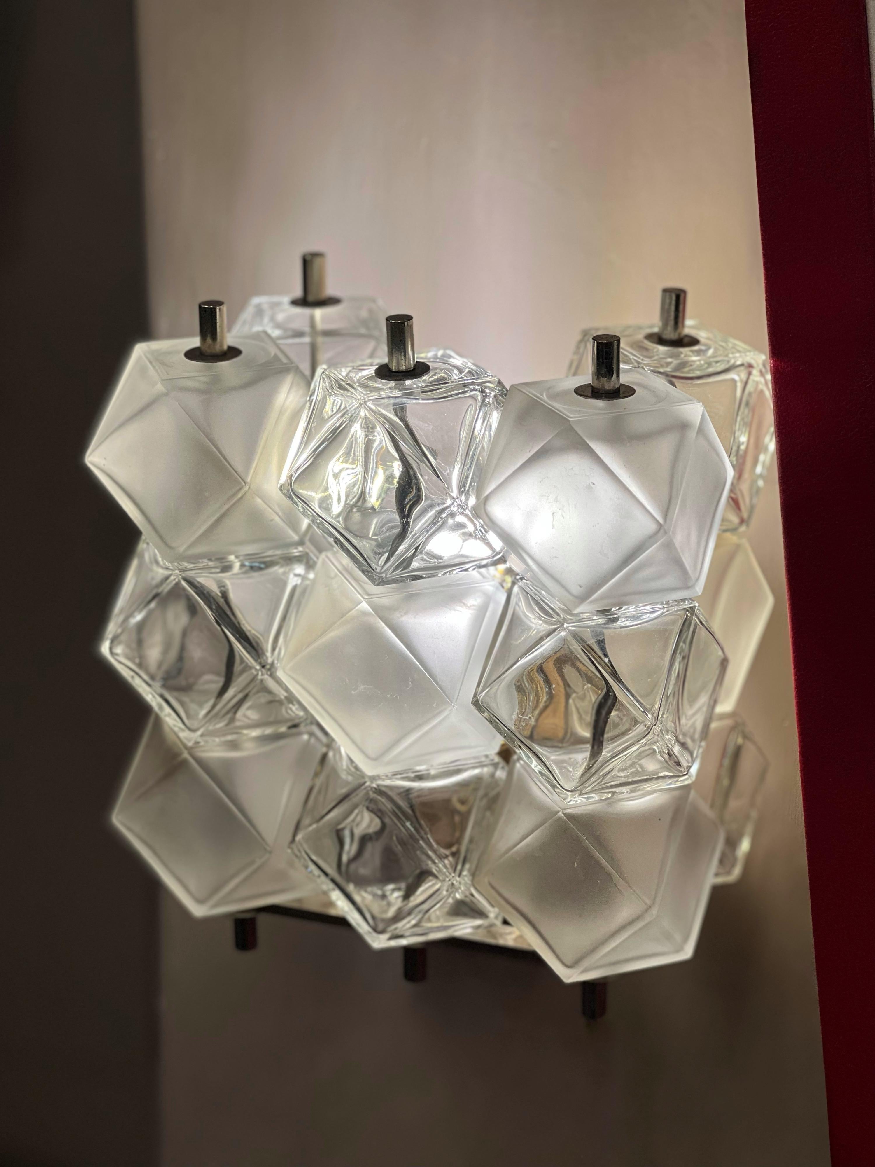 Set of three clear Murano glass wall sconces composed of satin and glossy polyhedral cubes by Aureliano Toso. Metal chromed fittings.
One light per sconce. Can be sold individually.