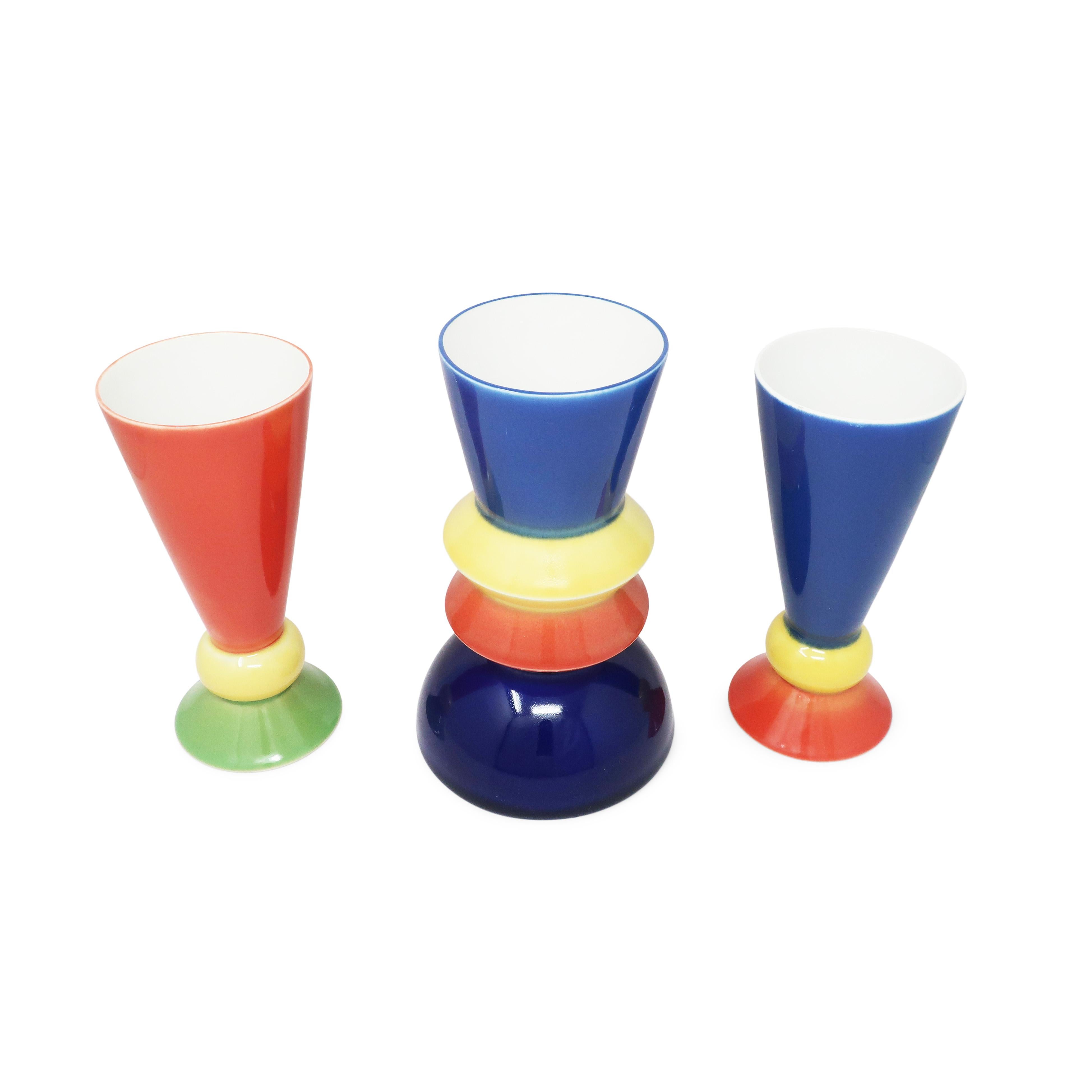 An outstanding set of three postmodern ceramic vases by Austrian artist and designer Heide Warlamis (born 1942). Part of Warlamis' Vienna Collection design series, these vases utilizes a fantastic mix of curved, angular, and graduated shapes and a