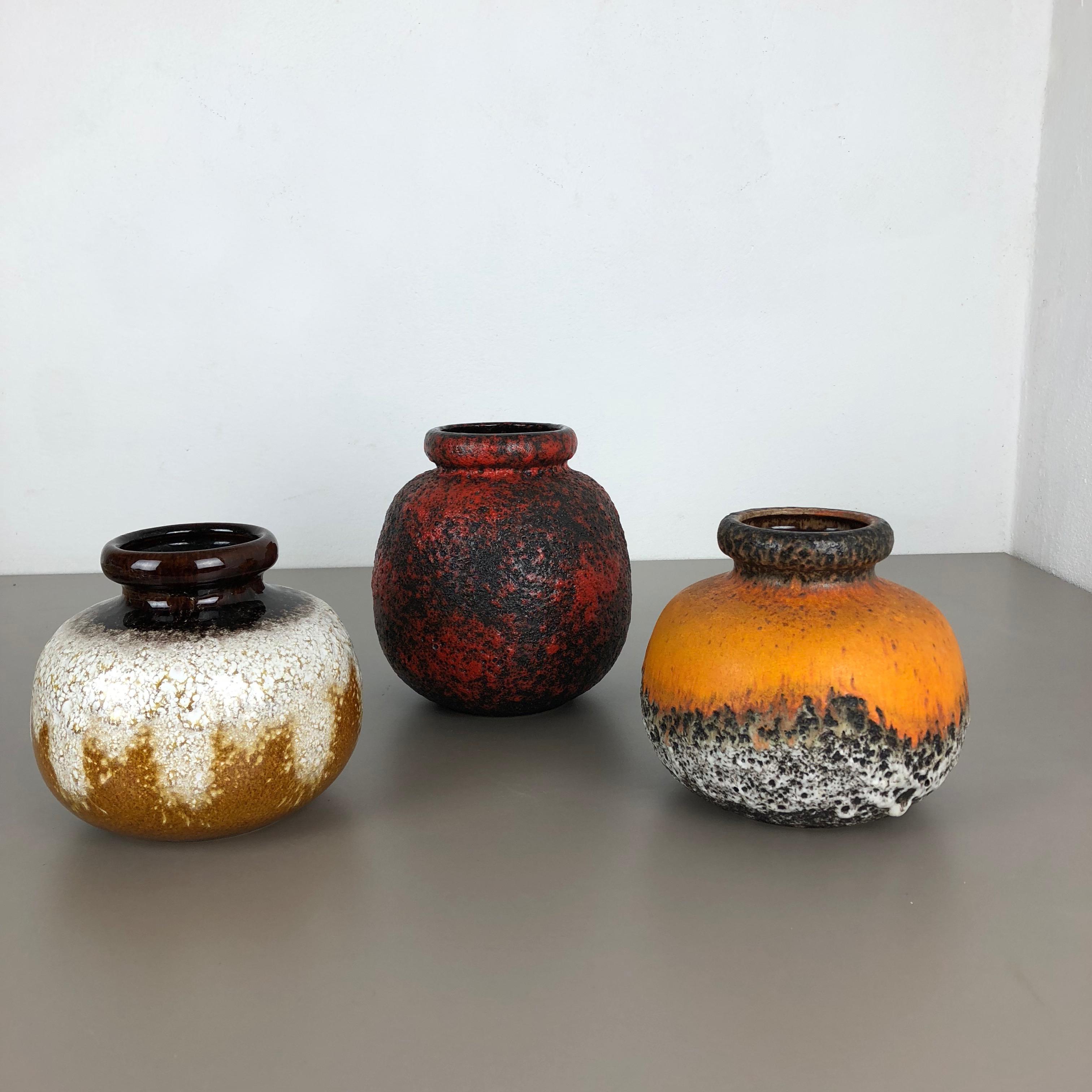 Article:

Set of three fat lava art vases

model:
234-15
284-19



Producer:

Scheurich, Germany



Decade:

1970s


Description:

These original vintage vases was produced in the 1970s in Germany. It is made of ceramic