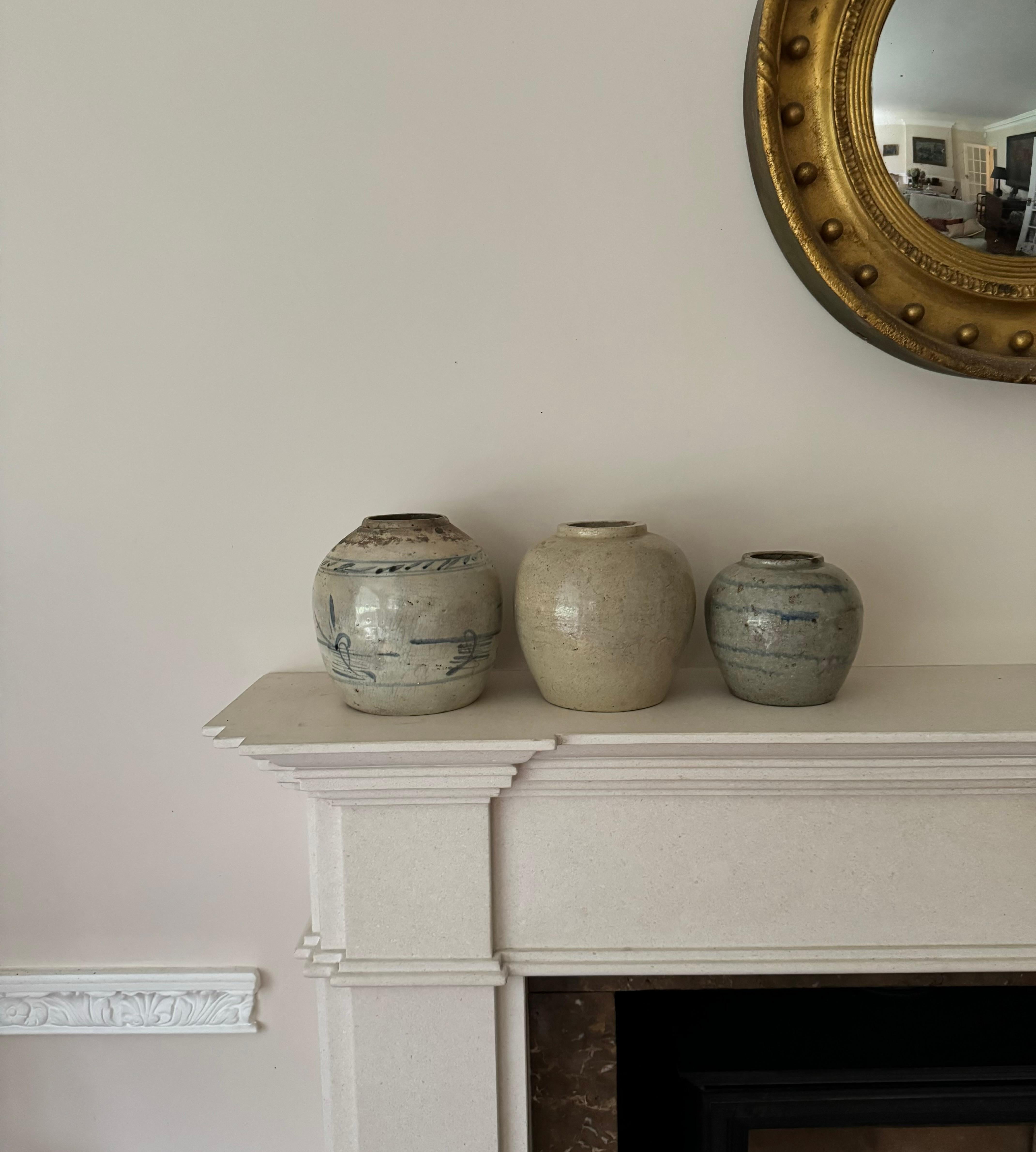 A set of three provincial glazed ginger pottery pots of varying sizes and with different motifs. Sold as a set. Tallest 16cm smallest height 13cm.