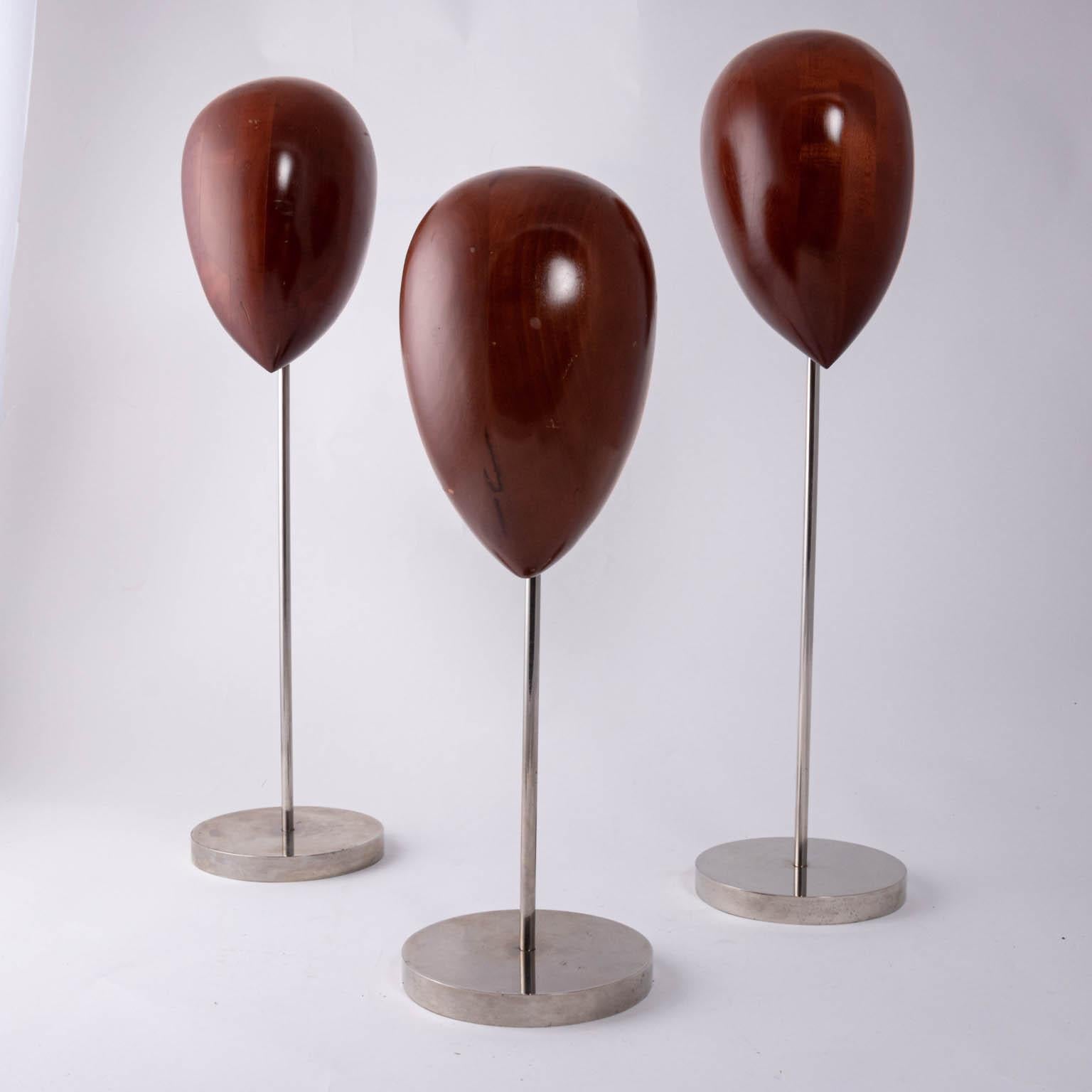 Set of three limited edition Ralph Lauren midcentury wooden heads on steel bases used as store props, circa 1980s. Please note of wear consistent with age including finish loss, wood loss, scratches, and chips due to daily use. Made in the United