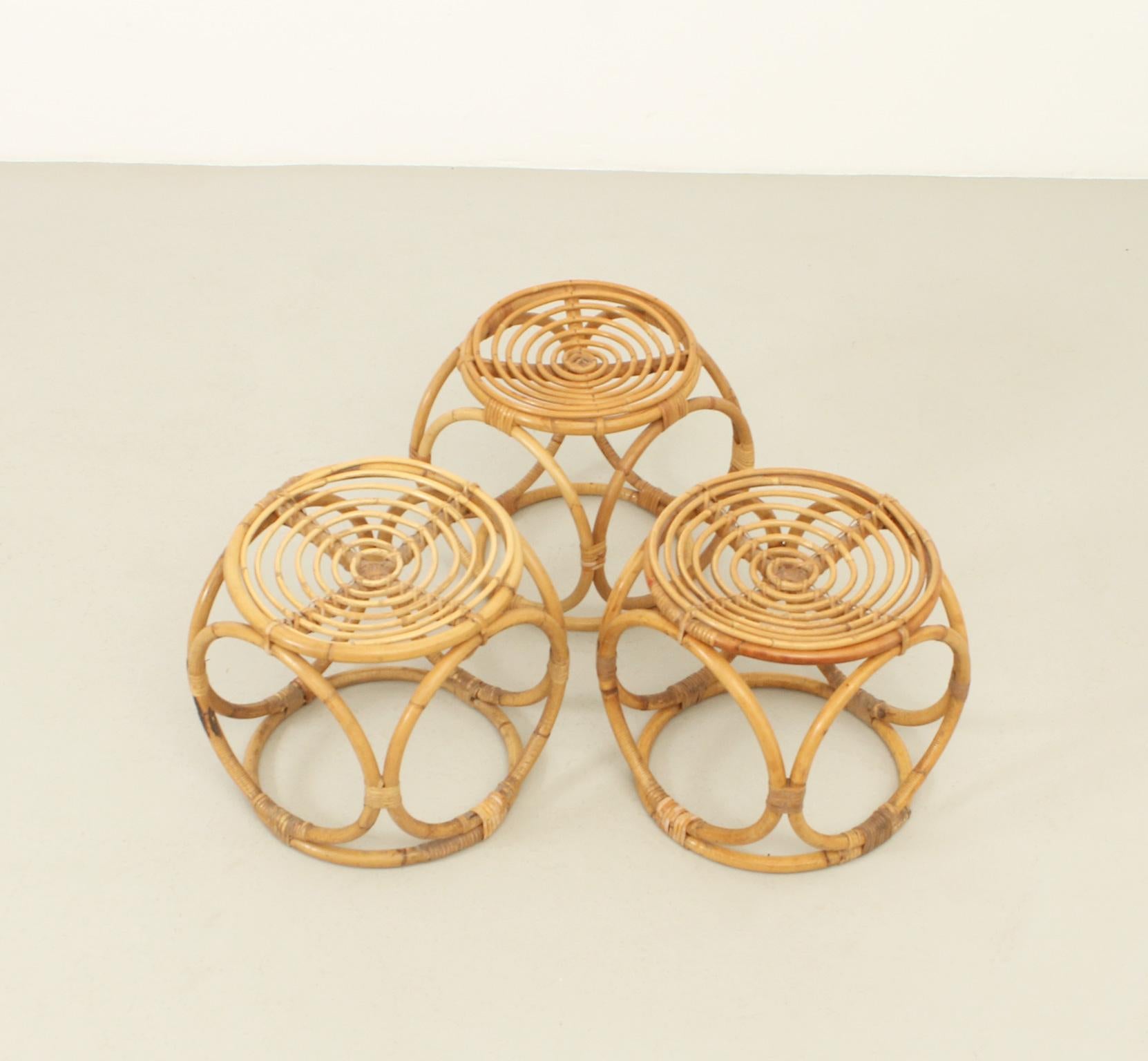 Set of three rattan stools from 1970's, Spain. Made with woven rattan with circular pieces. 