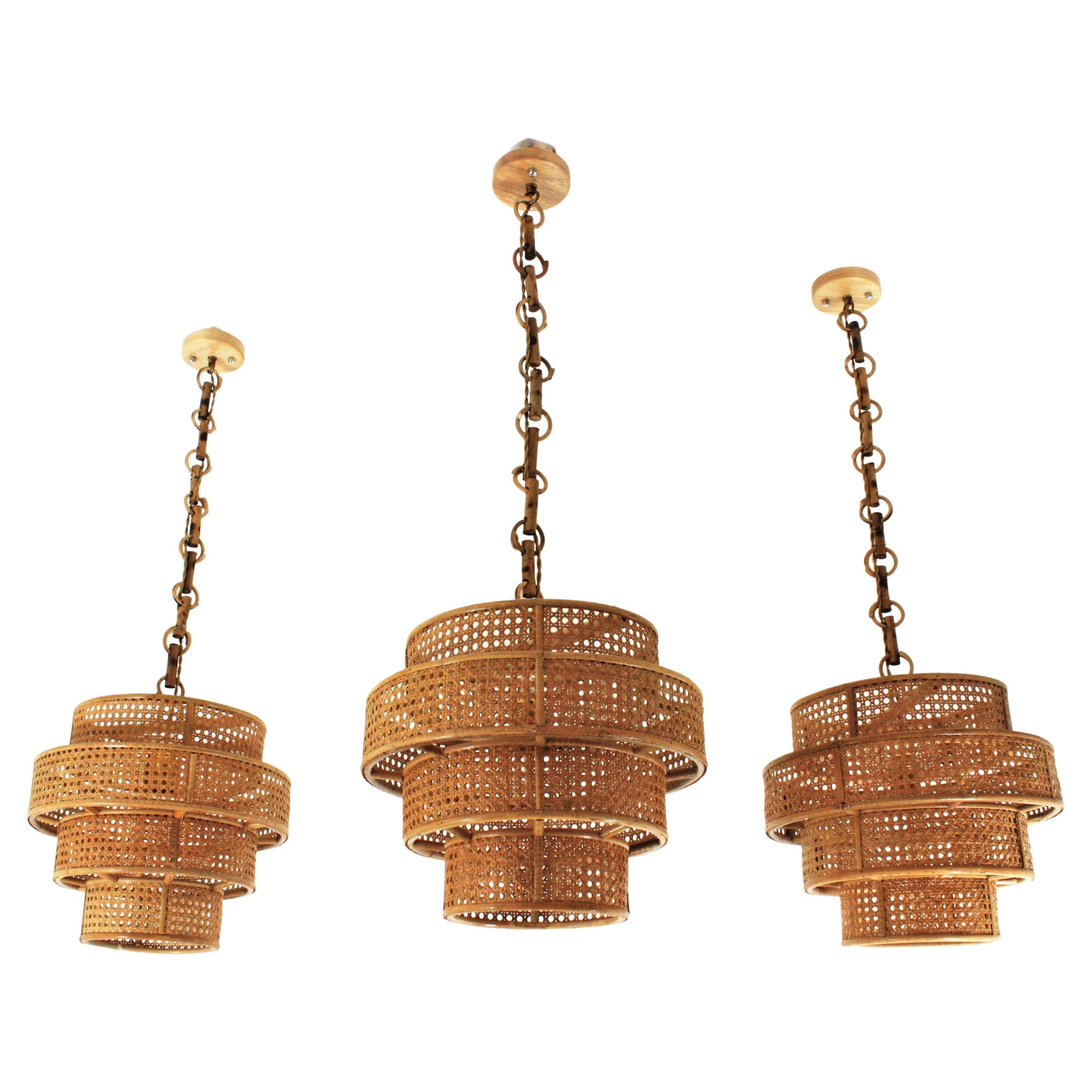 Large Rattan Wicker and Rattan Pendants, Set of Three
Set of three Rattan Wicker Weave Concentric Cylinder Pendant Hanging Lights. Italy, 1960s
Eye-catching set of handcrafted wicker weave concentric cylinder ceiling suspension lamps.
These