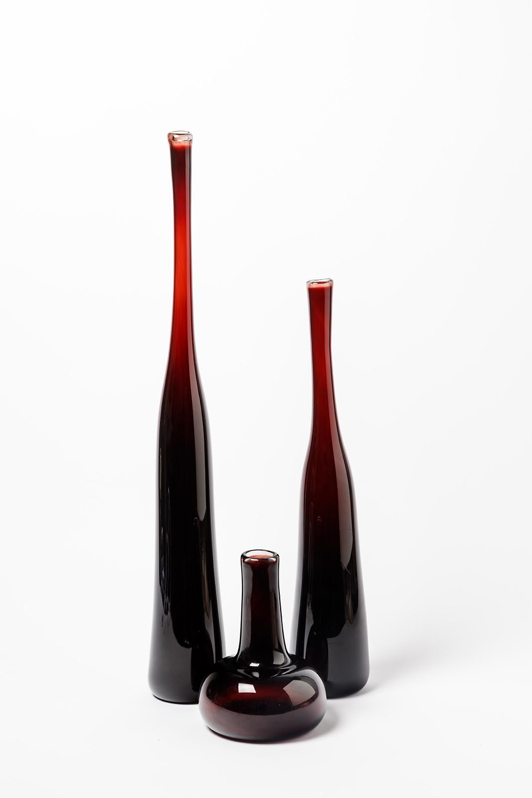 Claude Morin (1932-2021)

Exceptional set of three red glass bottles or vases by french artist CLaude Morin

All pieces are signed 

Original perfect condition

20th century glass design in rare red glass color

Dimensions 
number 1