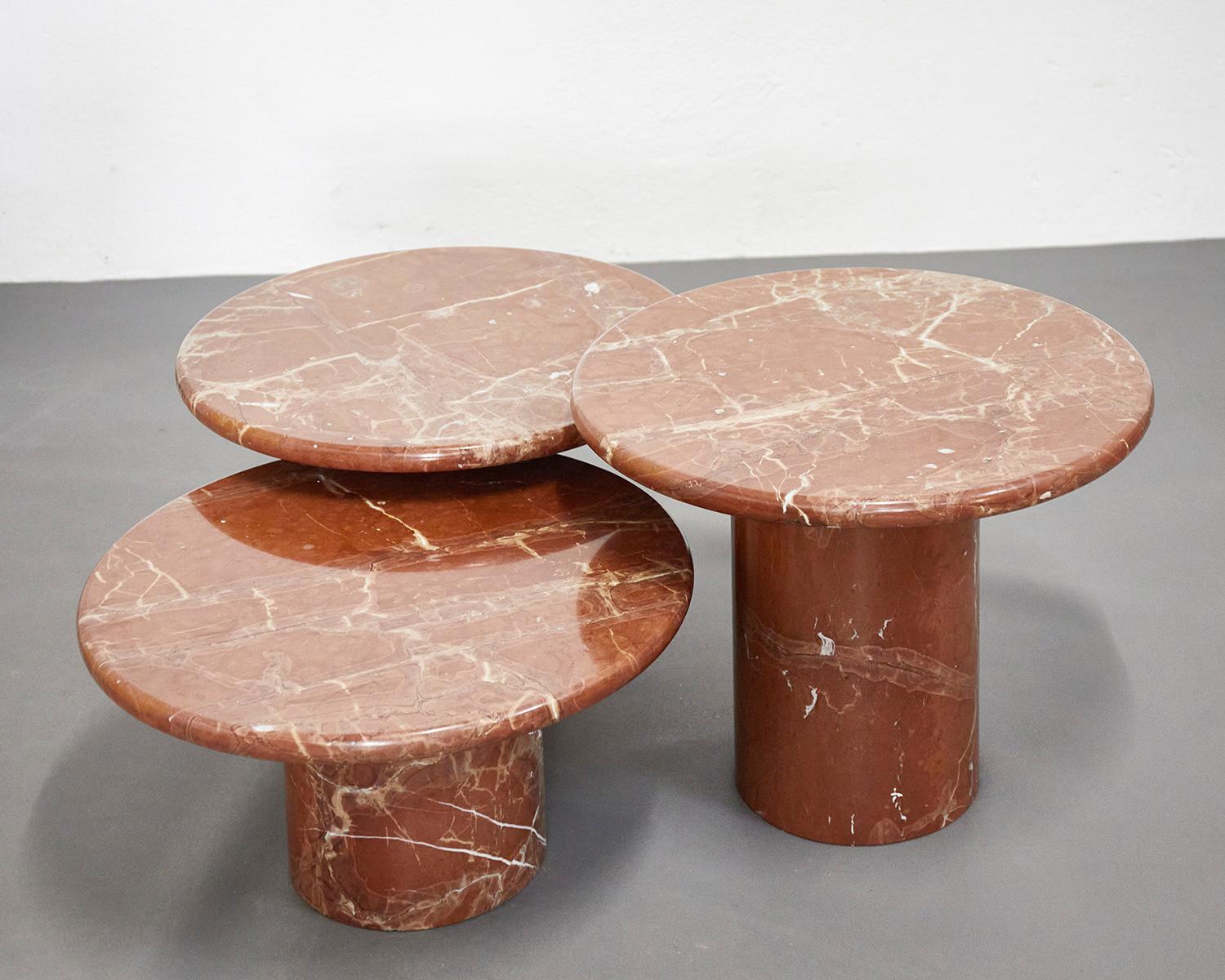 Set of three red Verona marble tables manufactured in Italy around 1980.

This rare set of coffee or side tables is entirely made of massive red Verona marble. Both the top as well as the conical shaped bases are massive which is extremely