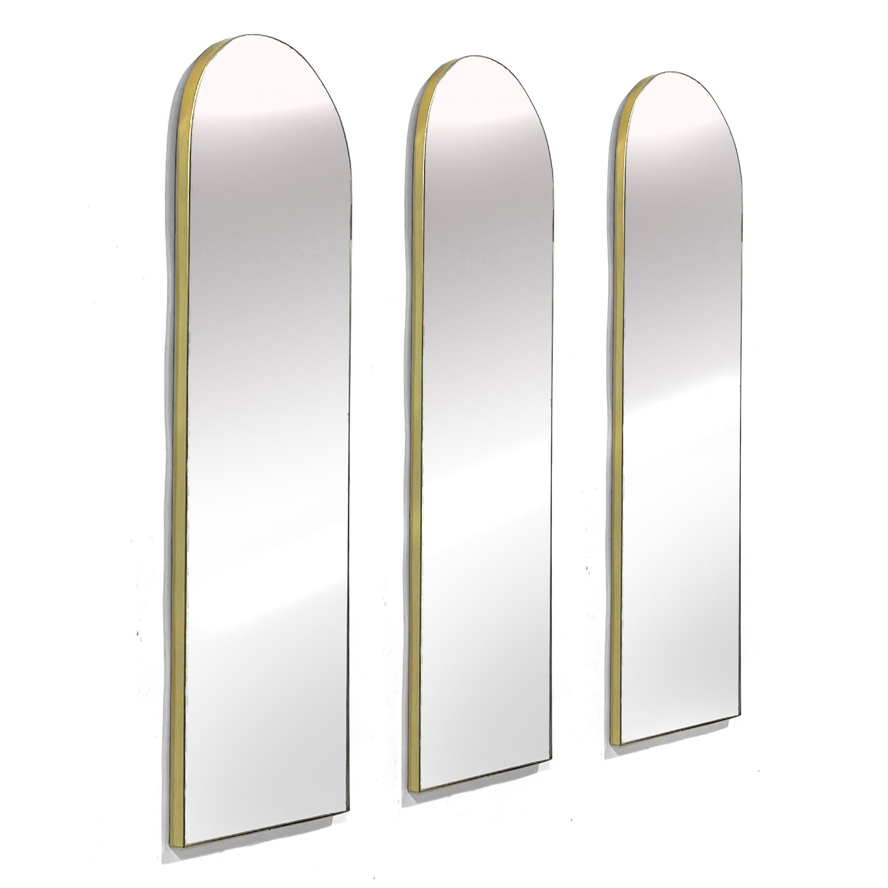 Ces trois miroirs muraux de Regent Glass Co., aux plateaux arqués et aux cadres élancés de couleur laiton, apportent la touche parfaite d'élégance minimaliste et sophistiquée.

Chaque miroir mesure 44,25 