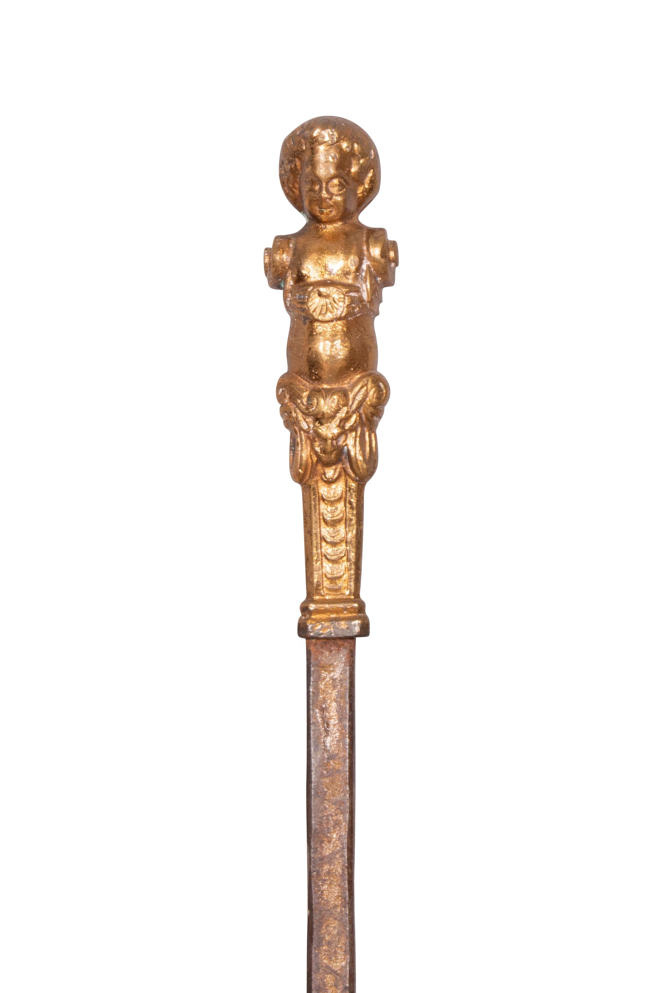 Three pieces with figural handles comprising a shovel, fork and poker.