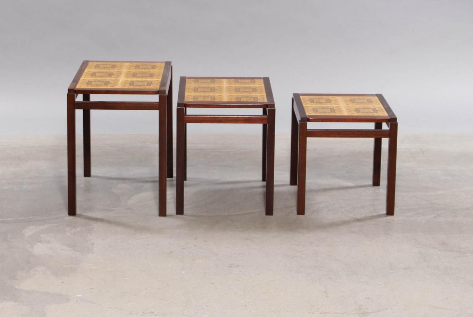 Danish furniture manufacturer. Nesting tables crafted in rosewood and decorative tiles. 