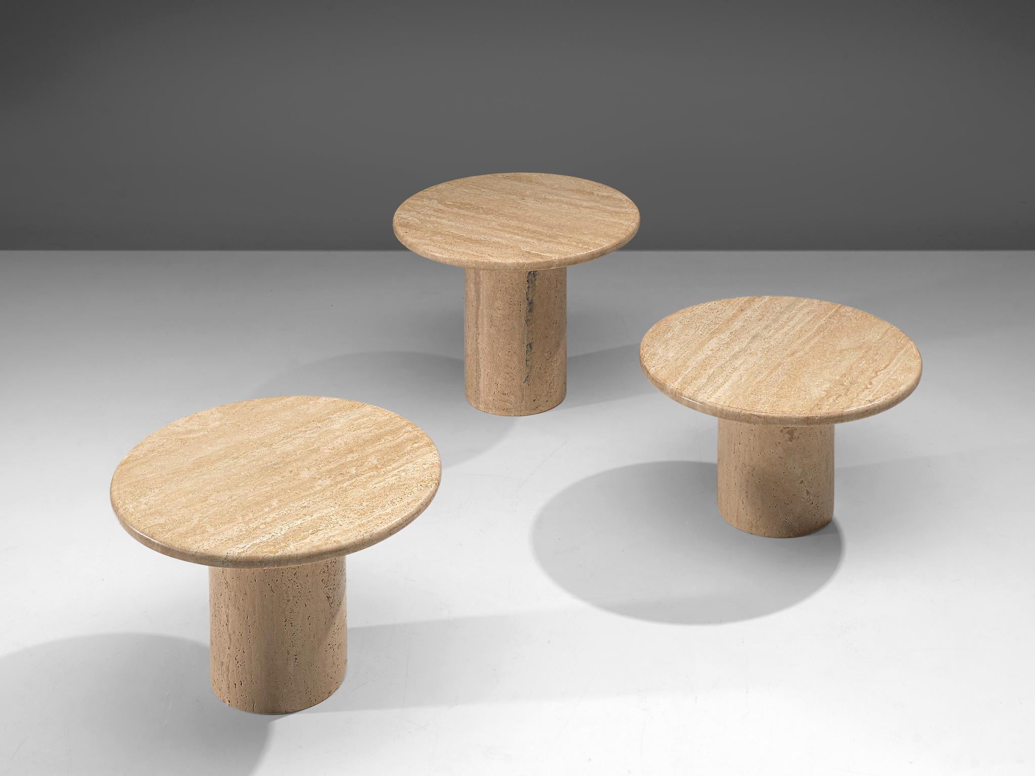 Set of three round travertine coffee tables, Italy, 1970.

This set of cocktail tables feature a round foot and a circular travertine tabletop. The circular tables have no joints or clamps and is architectural in its structure. Every tabletop