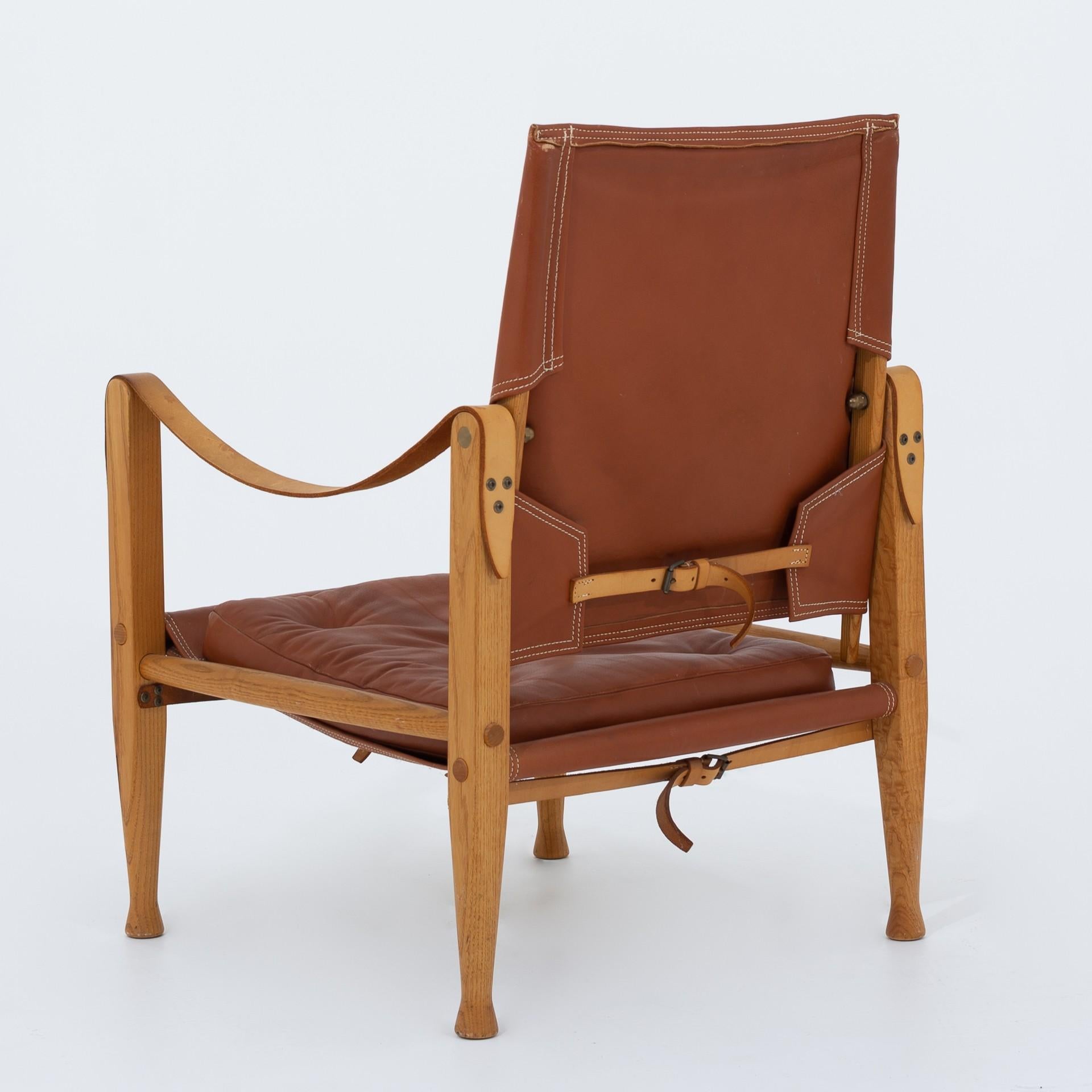 Three safari chair in ash with cushions in cognac leather. KK 47000. Maker Rud. Rasmussen.