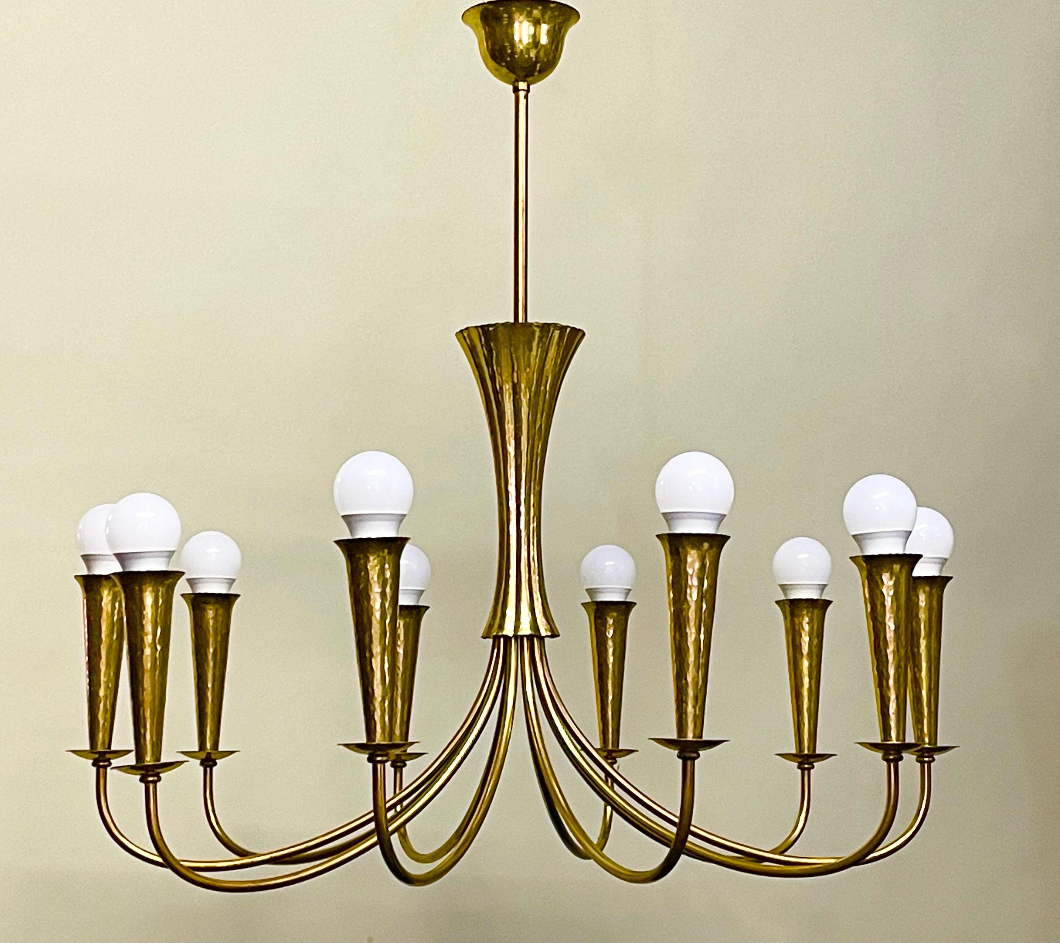 A set of three mid- century Scandinavian hammered brass light fixtures ( chandelier and a pair of wall sconces), circa 1950s.







 