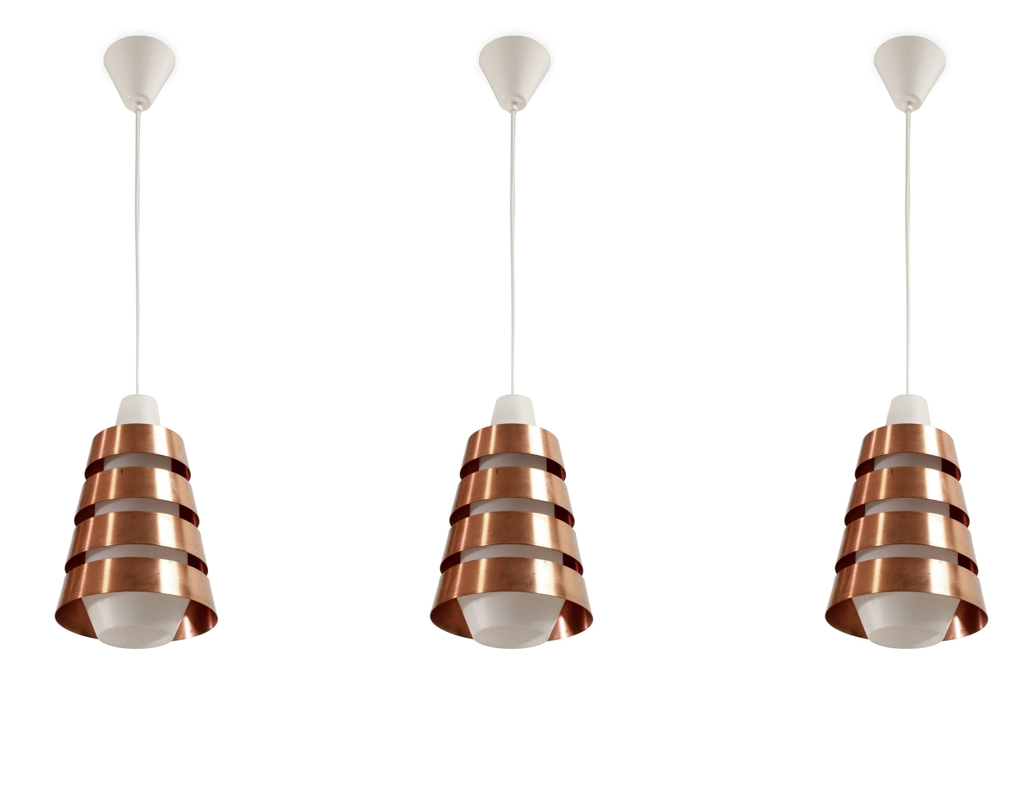 Outstanding and large ceiling lamps in copper and shades in opaline glass. Most likely designed and made in Denmark, circa 1960s second half. The lamps are fully working and in very good condition.