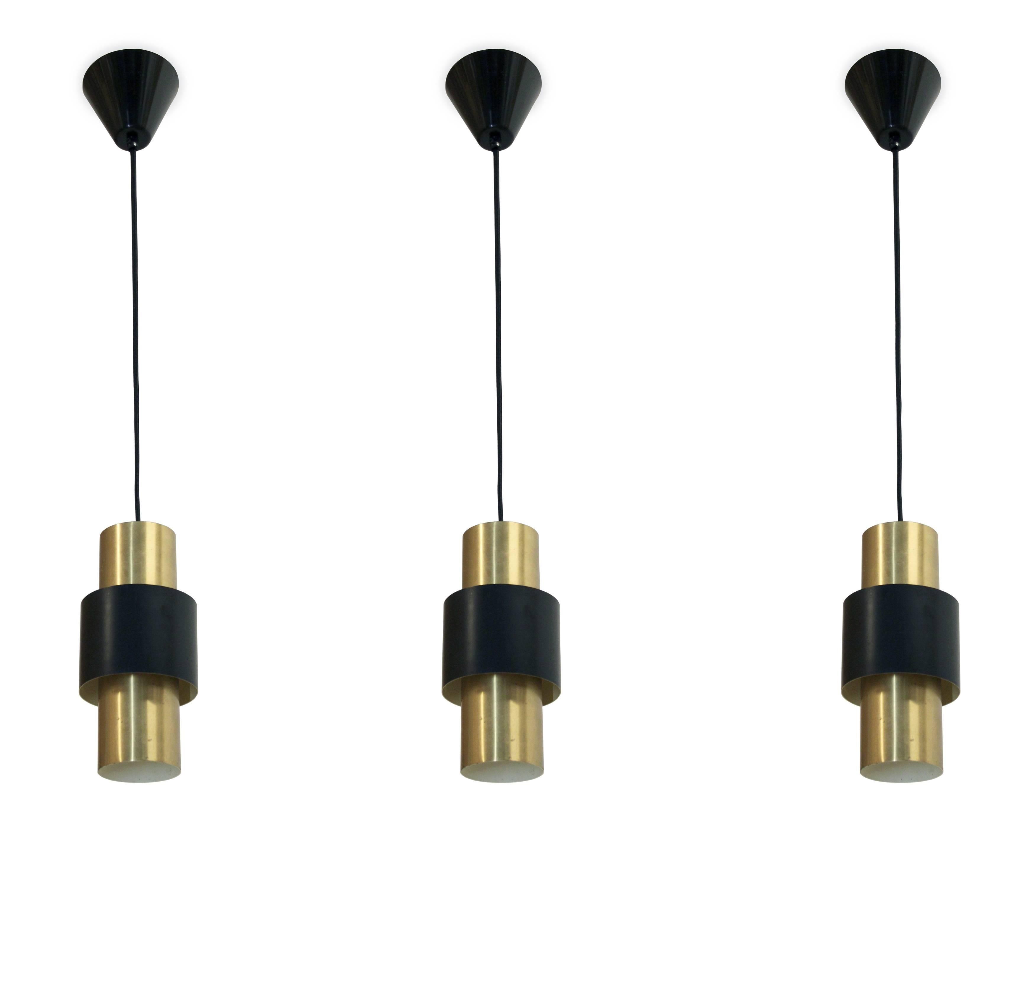 Beautiful set of three ceiling pendants in brass and painted steel. Designed by Jo Hammerborg and made in Denmark by Fog & Mørup from circa 1960s first half. All lamps are fully working and in good vintage condition.
