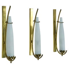 Set of three sconces in brass and triplex opaline glass in Arredoluce manner. It