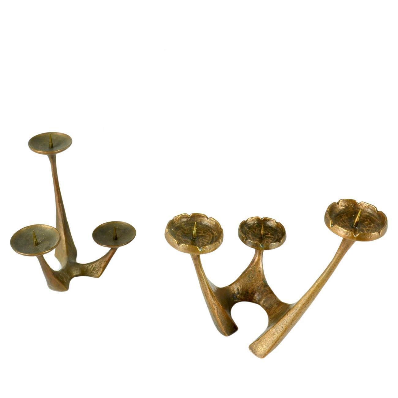Three free form bronze cast candelabras folding candles on alternating heights. They hold candles from regular up to 6 cm Their organic shapes and texture make them very sculptural.
They will make great decoration for the festive season.

Priced and