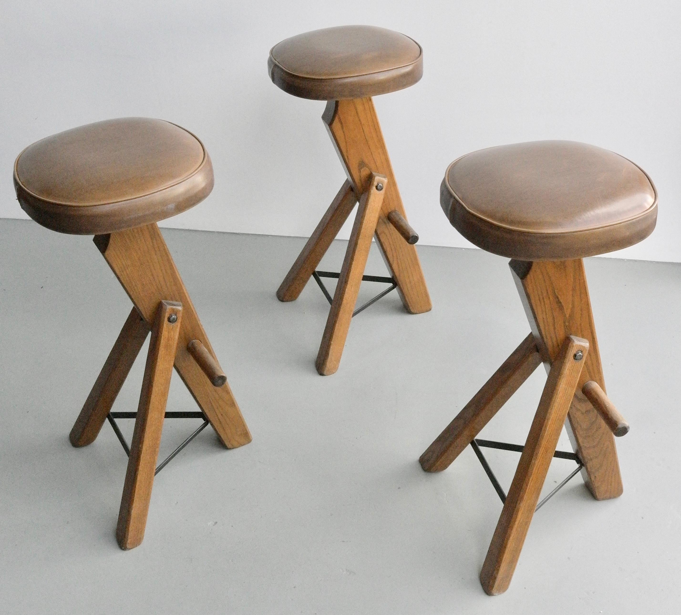 Set of three sculptural oak barstools, France, 1960s.