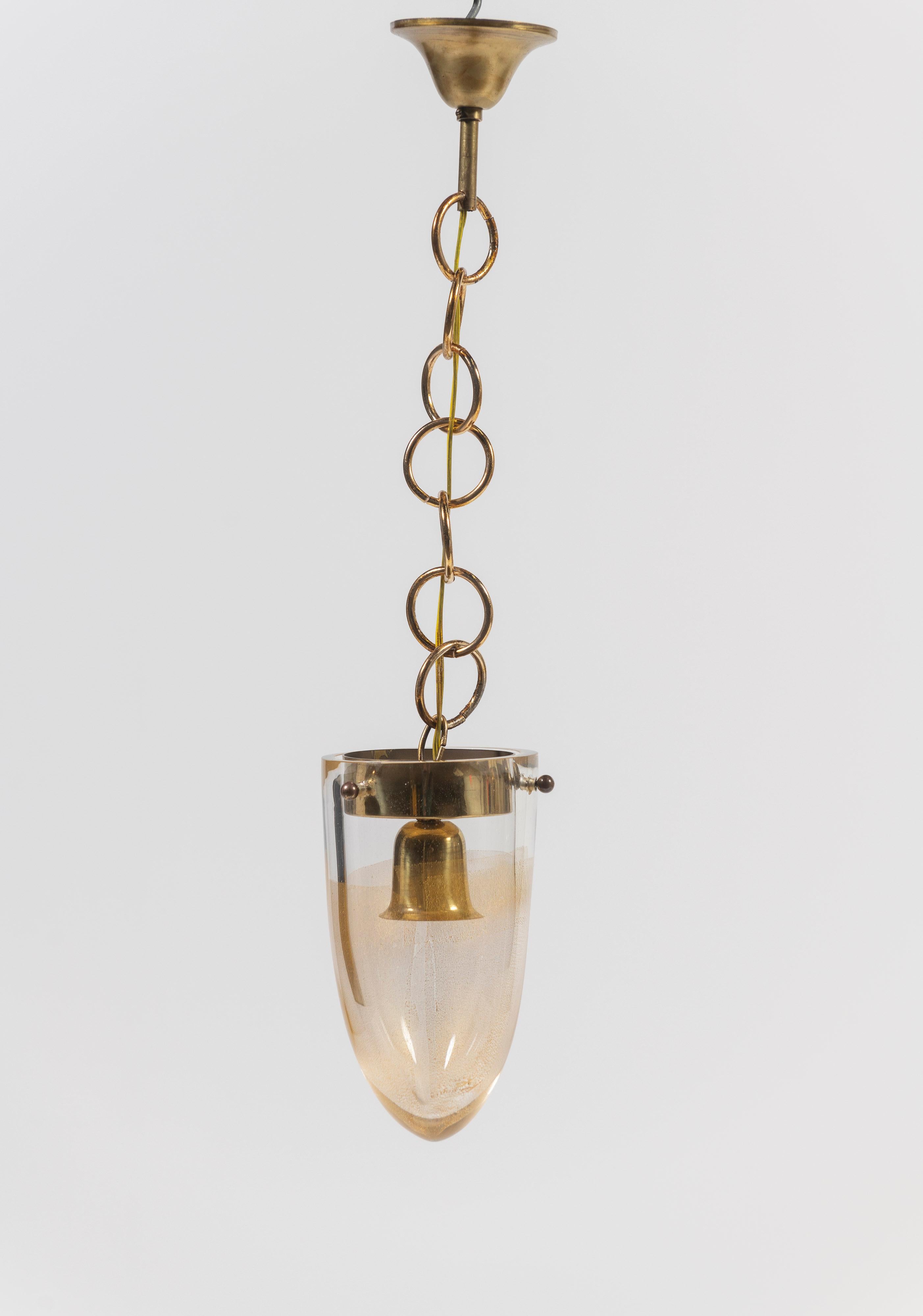 Sold as a set of three, these gorgeous Murano blown glass pendants, with gold dust inclusions, are a great grouping to illuminate the space over a counter, in a hallway, over a table or in the bath. All three pendants hang on 10 inch circular chains