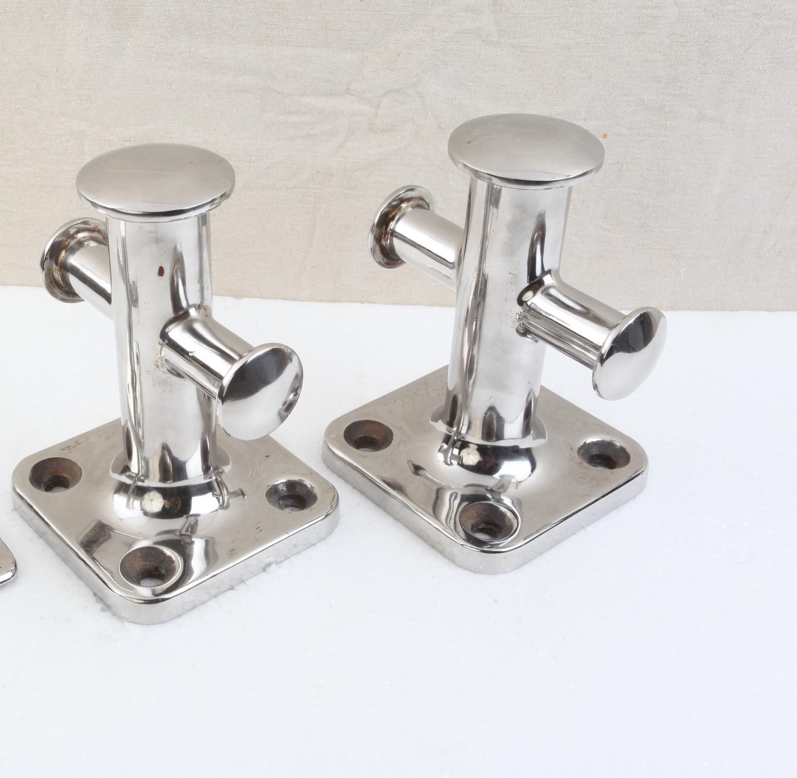 A pair of sampson posts, two large and one smaller. Chrome over iron. The chrome has been reapplied. Working cleats from a large ship. 1970s.  These can be mounted on teh wall making for ideal coat or towel hooks.  Each is 6