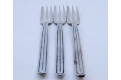 Set of three silver cake forks w/ three tines & raised trim along the handles