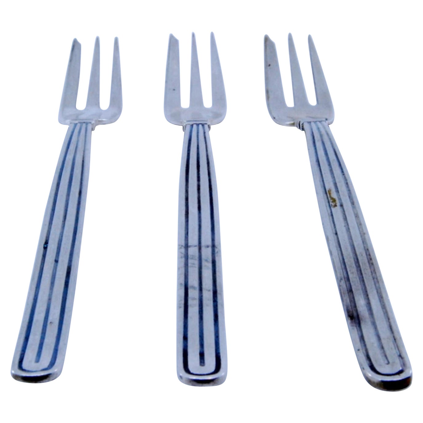 Set of three silver cake forks w/ three tines
raised trim along the handles