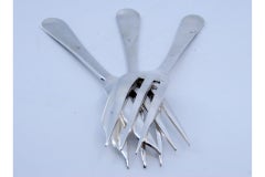 Set of three silver cake forks with grooves along the handles
