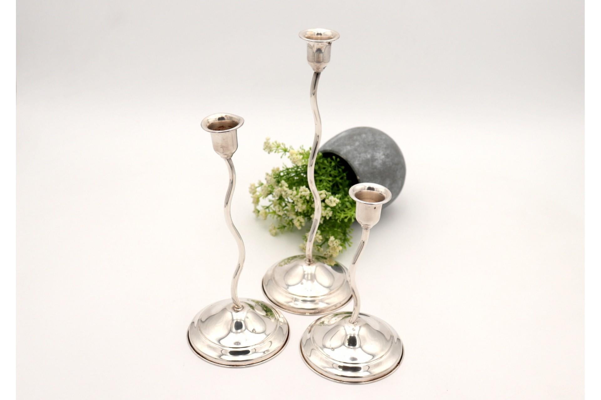 Description: Set of three silver candlesticks in various sizes, smooth and twisted stems with filled bottoms. Metal: Silver. Origin: Italian. Brand: Padua (missing). Weight: 762.18 grams. Dimensions: Measurements on request. Content: 800/1000. Assay