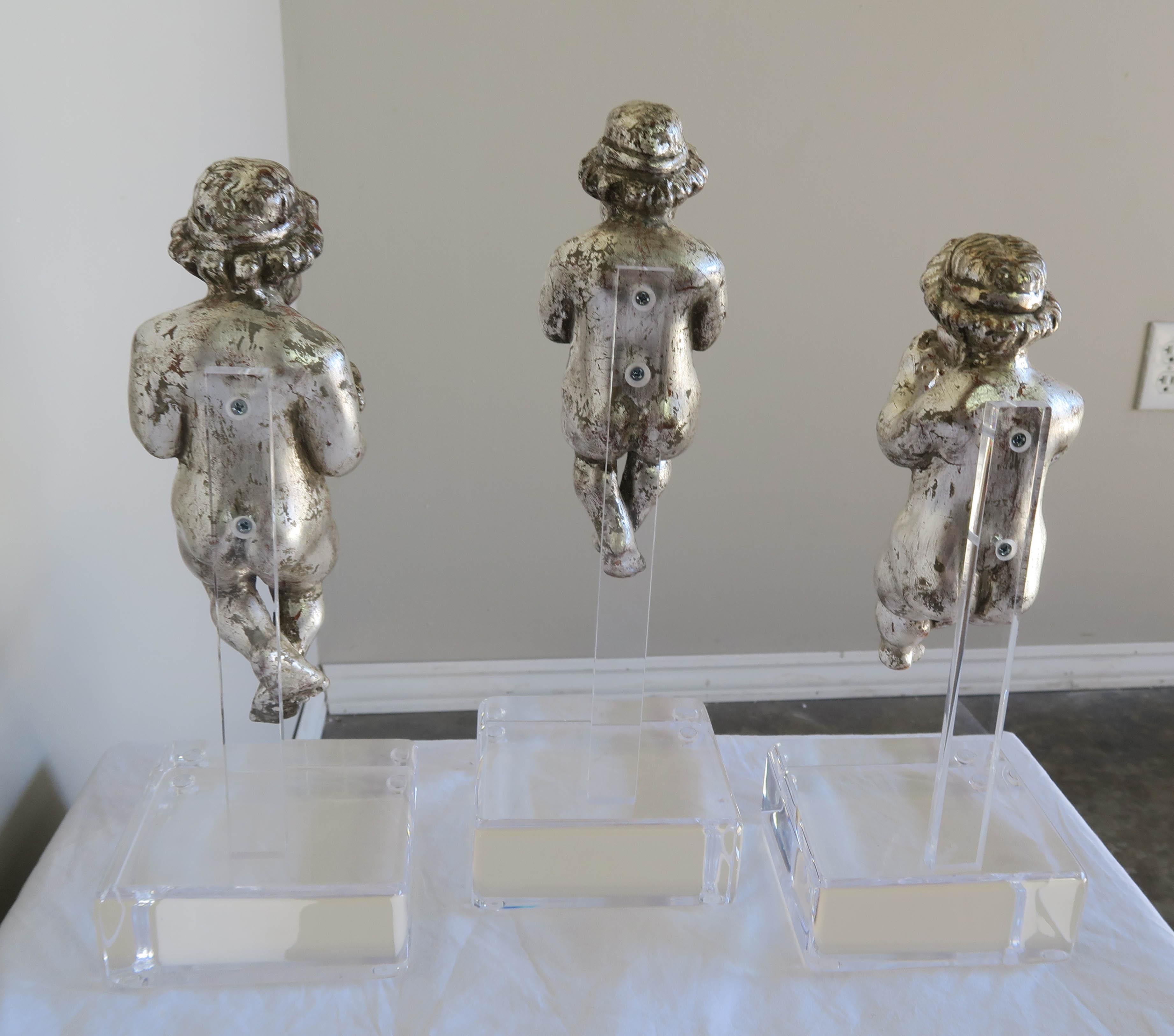 Set of three silver gilt musical Cherubs mounted on Lucite bases.
Measures: Cherub with horn 12