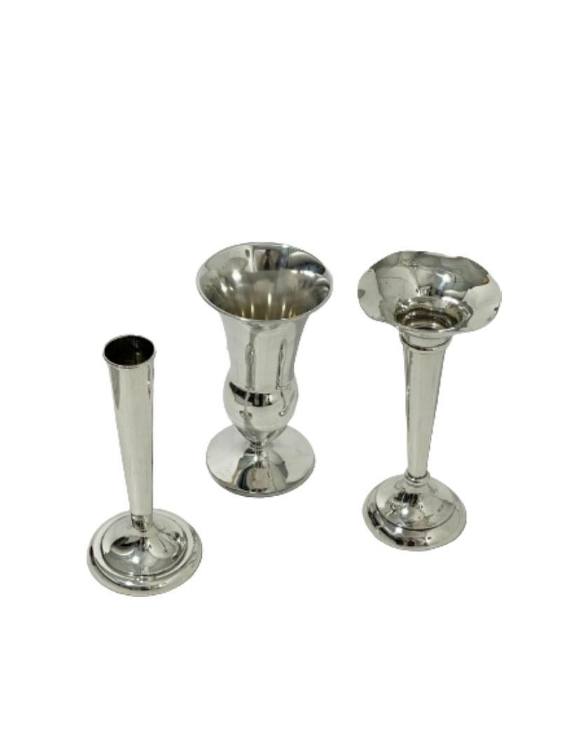 Set of three Silver small vases

Lovely set of three small Silver vases

* The wide trumpet with round belly is a Dutch Silver vase, made by Gerritsen & van Kempen, Zeist. The mark is used during 1926-1961. Marked with the Dutch Sword 835/1000