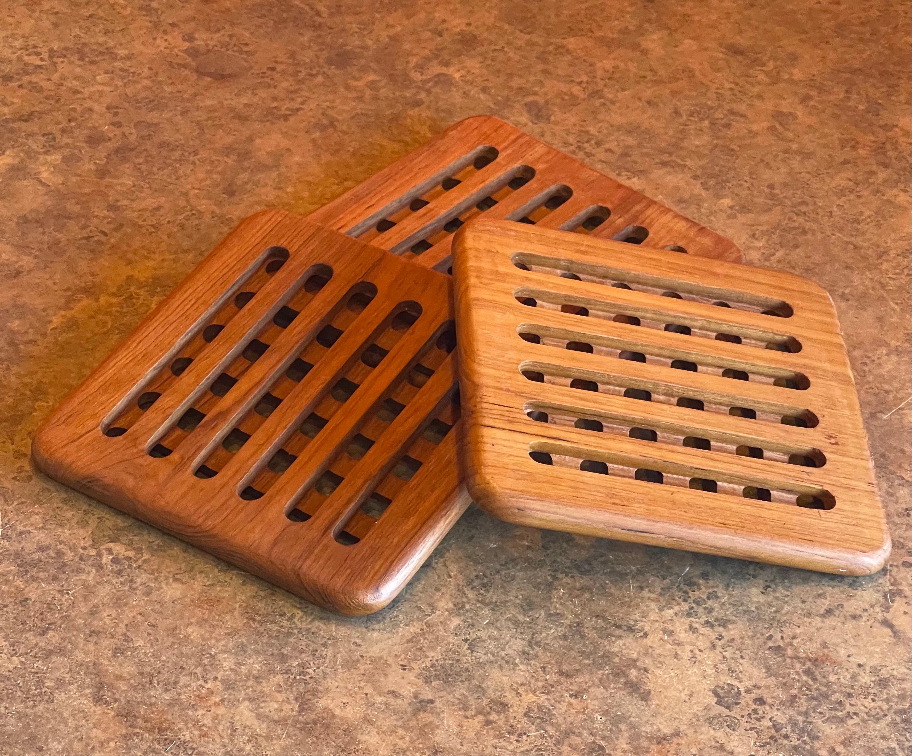 Set of three solid teak MCM trivets, circa 1980s. The trivets measure 7.75