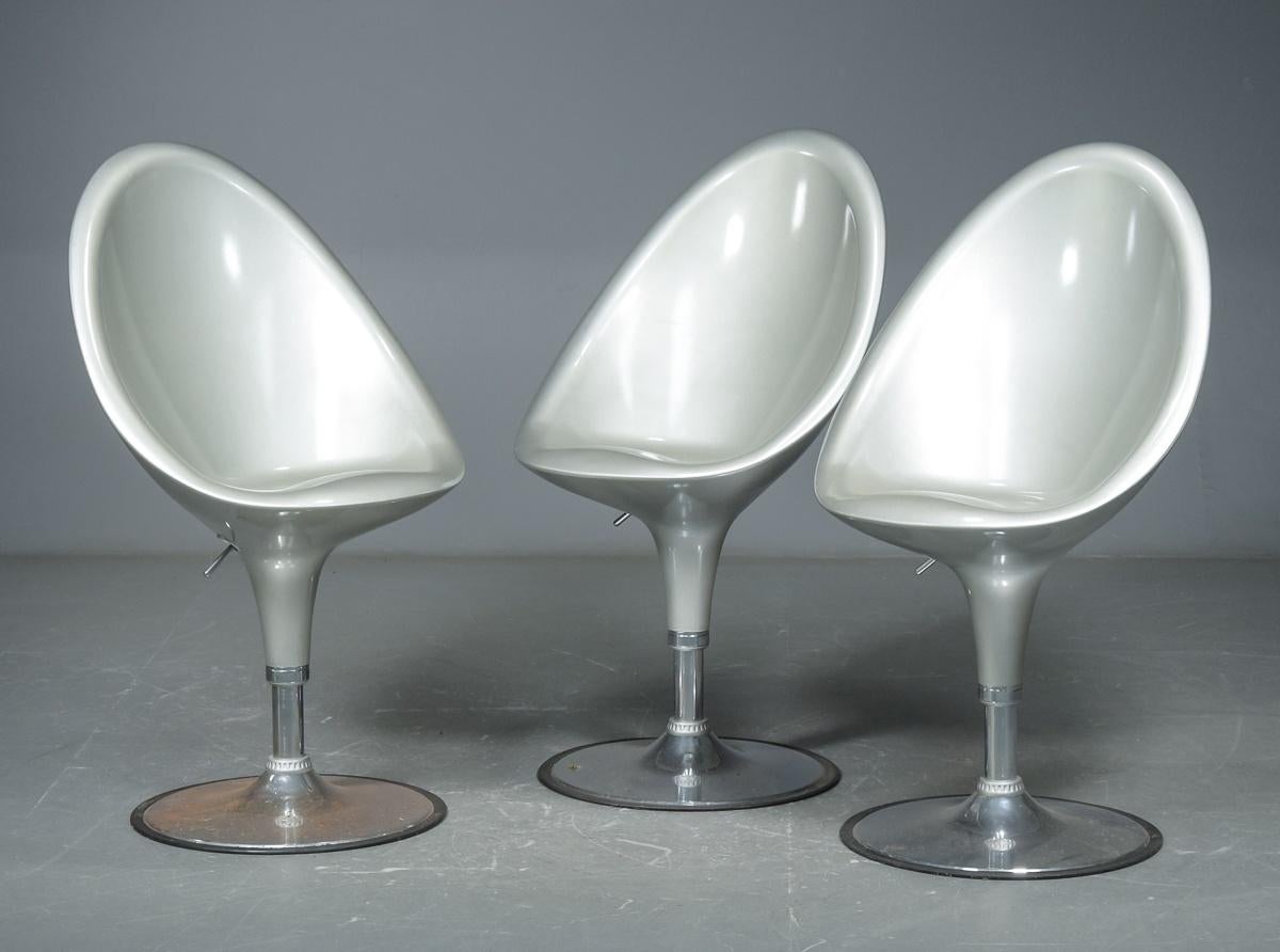 Set of three Postmodern barstools with fiberglass shells and chromed tulip style bases. Seat height is adjustable.