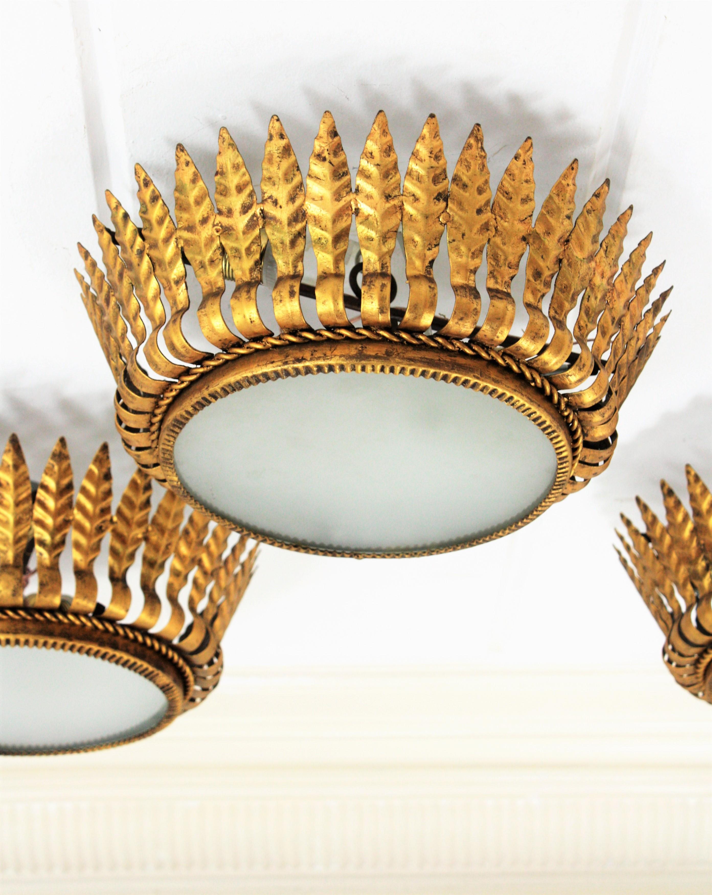 Mid-Century Modern Set of Three Spanish Gilt Metal Crown Light Fixtures with Leaves & Frosted Glass