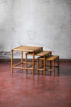Set of three stackable rattan tables 1980