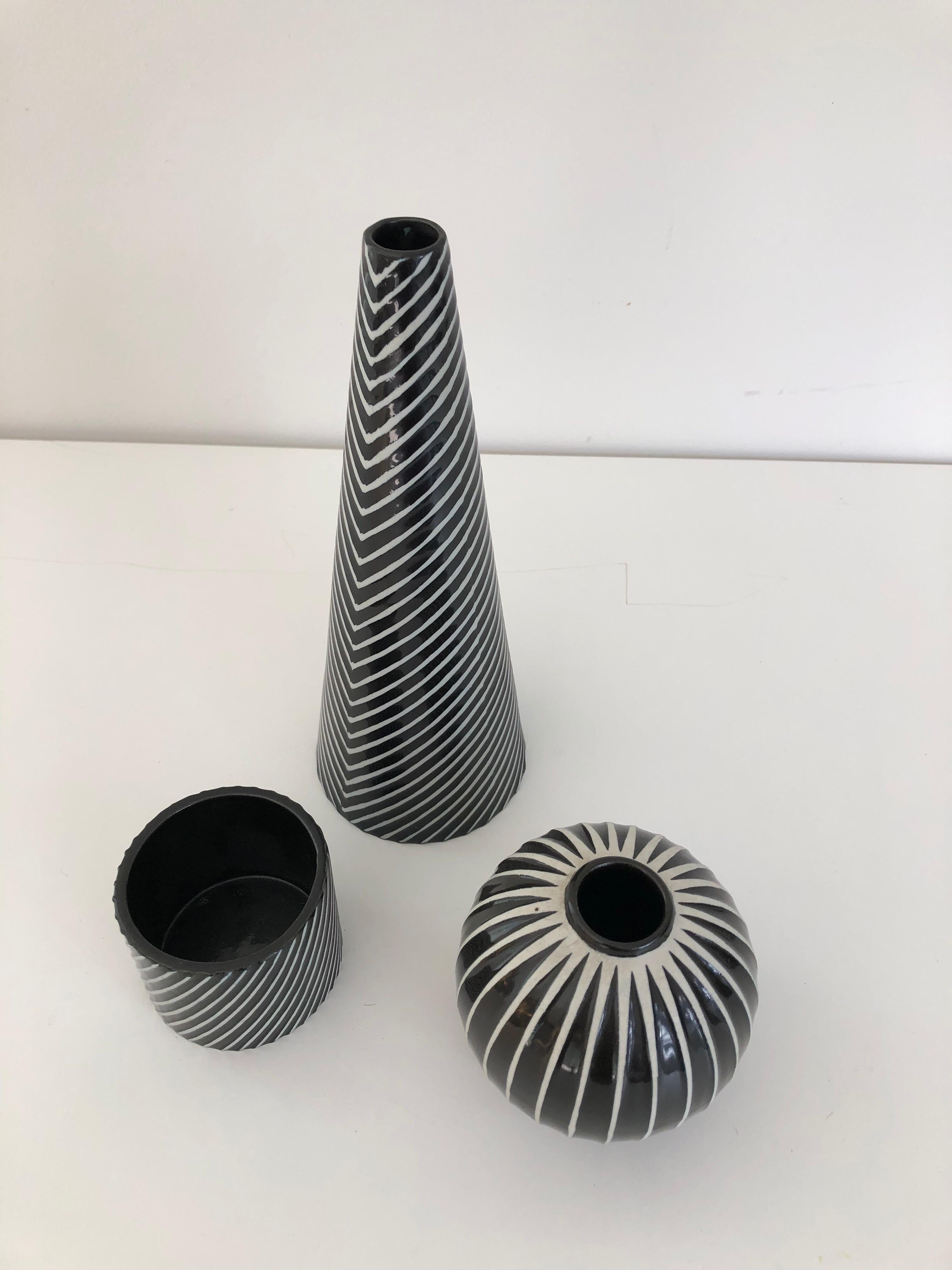 A set of three Stig Lindberg for Gustavsberg, Domino vases. Wonderful associated collection. Cone vase measures 9.25