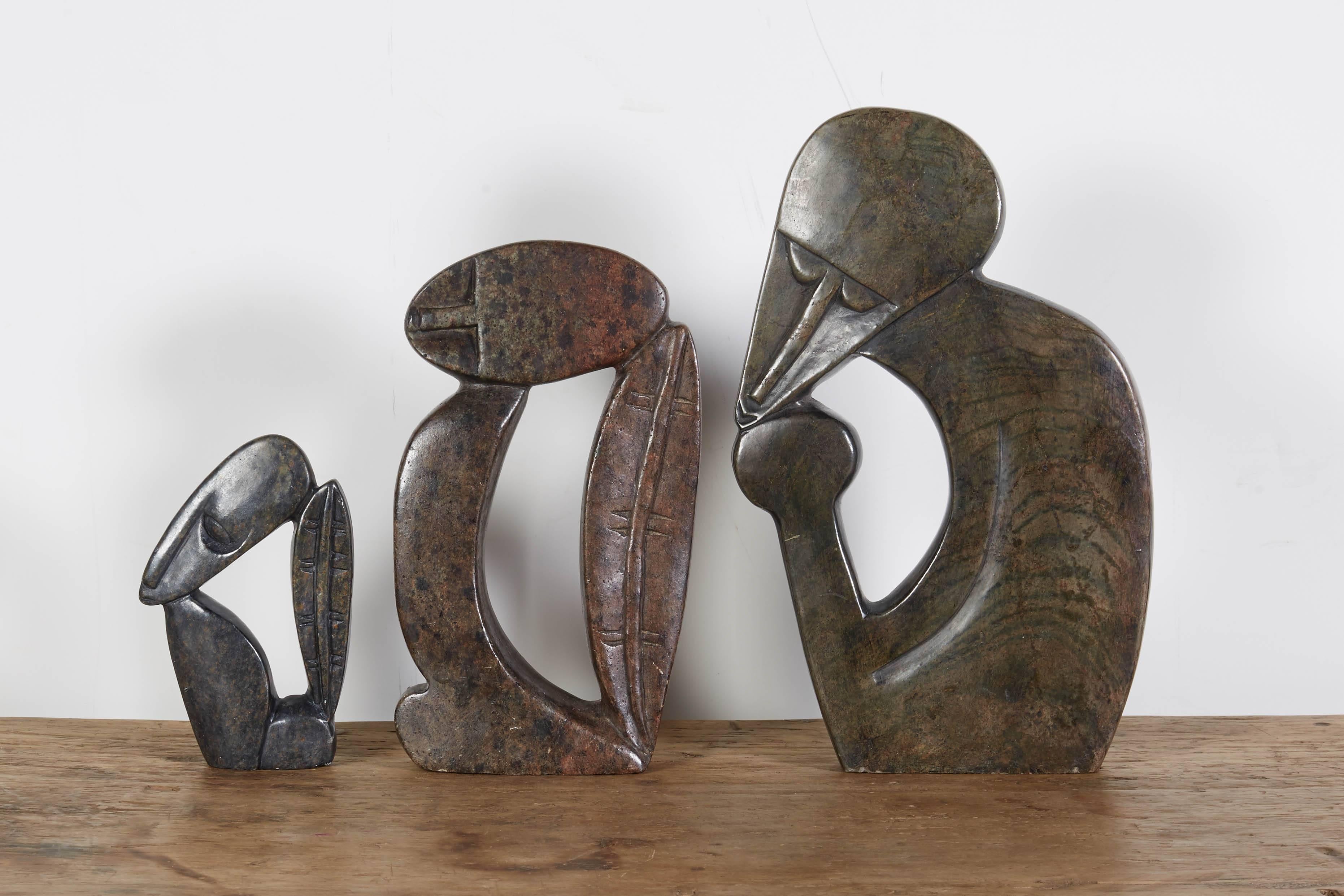 An expertly carved set of three striking stone sculptures from the Shona tribe of Zimbabwe. 
Dimensions: 
Large: L 7, D 1, H 11
Medium: L 5, D 1, H 9
Small: L 3, H 6.