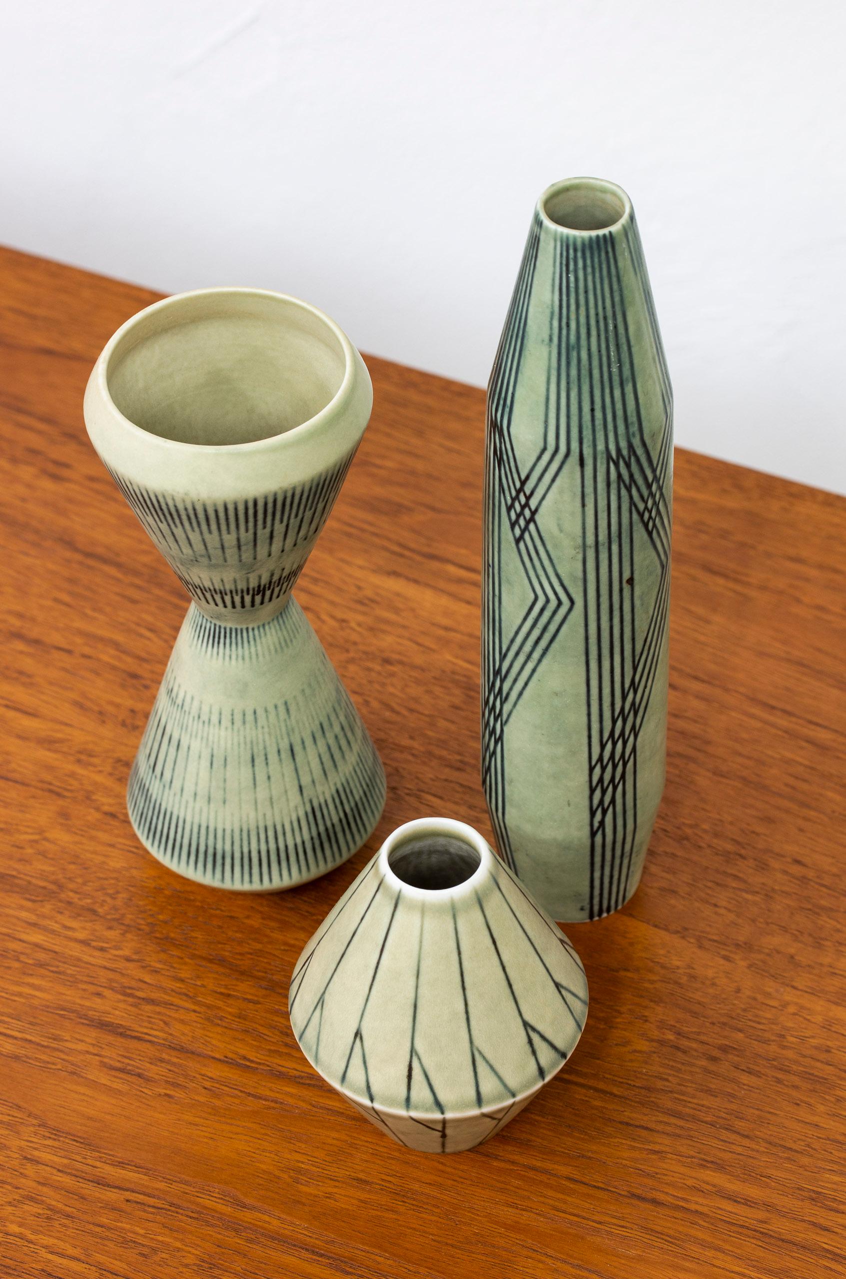 Set of htree vases designed by Carl.Harry Stålhane. hand made at Rörstrand in Sweden during the 1950s. Made from stoneware with abstract decor on light green glazes. Very good condition with light age related patina.

Dimensions: H. 11/20/25.5 Ø.