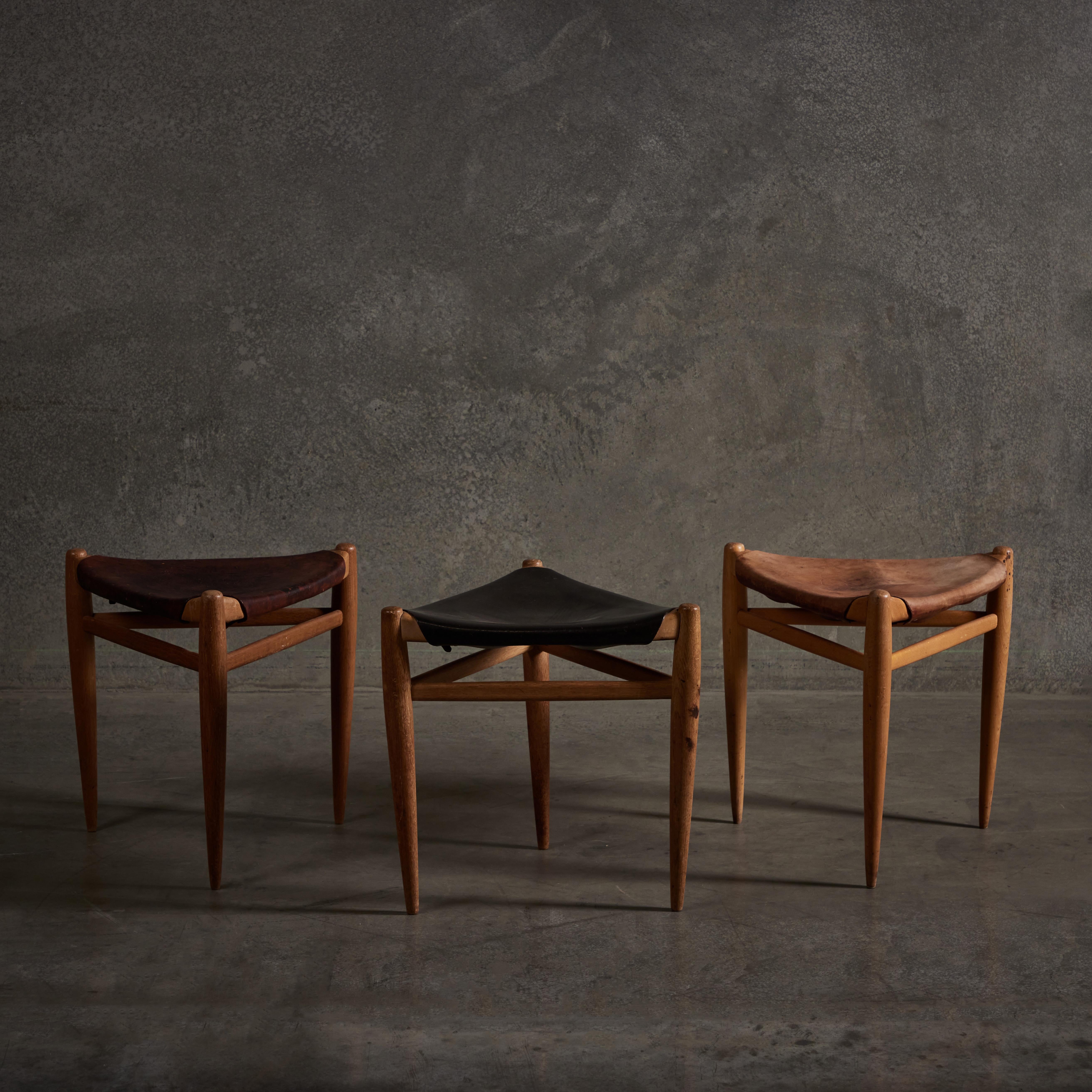 Set of three patinated leather Stools by Uno & Östen Kristiansson for Luxus, Vittsjö. Made in Sweden circa 1960s.