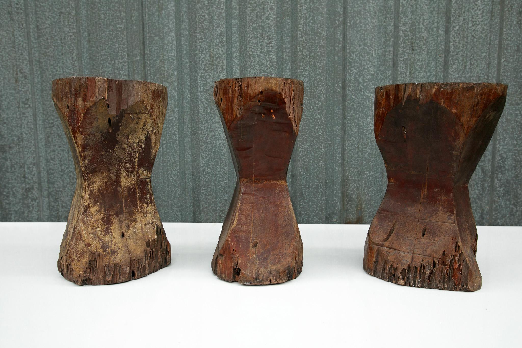 This beautiful set of three Brazilian modern stools was designed by Jose Zanine Caldas in the seventies. The stools are completely made out of Pequi hardwood and the top and bottom are flat, while the middle section is carved in. These wooden stools