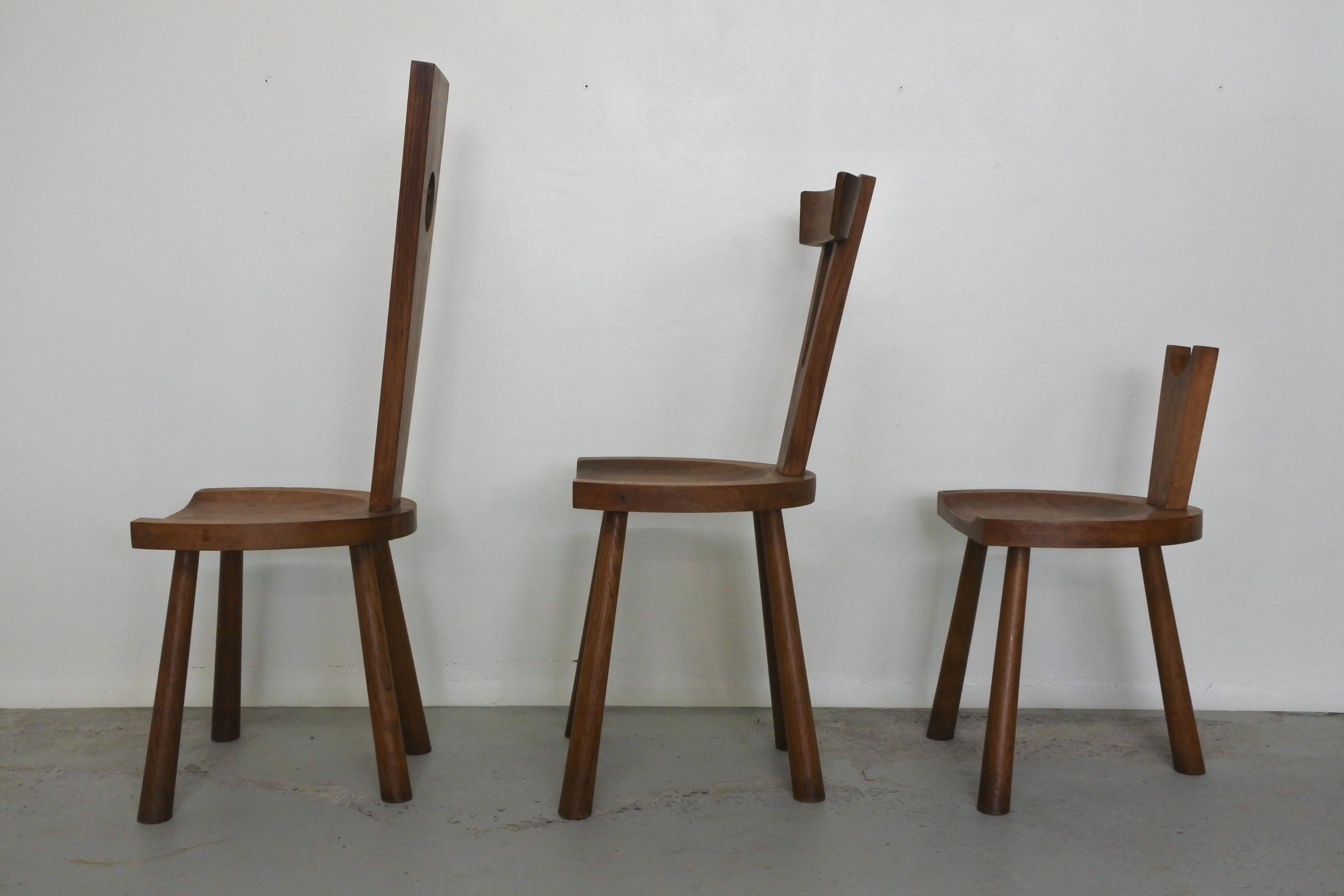 Set of 3 woodworker's studio chairs.
Solid oakwood.
Made in France in the 1950s.

Very sculptural.

Measurements:
Tall: Height 96 cm, depth 40 cm, width 40 cm, seat height 38
Medium: Height 83 cm, depth 40 cm, width 40 cm, seat height