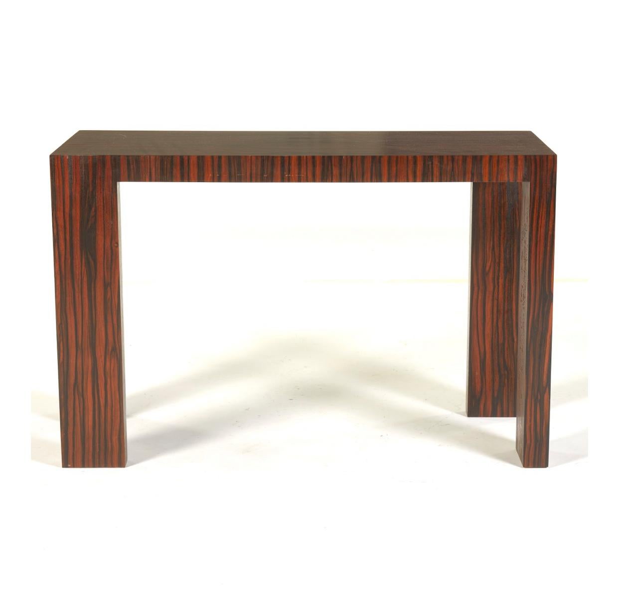 Bespoke designed and constructed by Brian Miller of Avalon, PA, are a set of three graduating console tables covered in Macassar ebony veneer, ca. 1990s. Macassar ebony veneer was a widely used wood of the Art Deco period. The legs are uncommon with