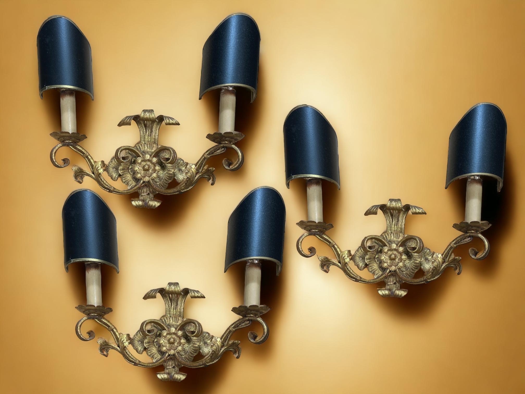 A set of three mid-century Hollywood Regency wall sconces with gold leaf. Two European E14 candelabra lamps with up to 40 watts per socket are required for each lamp. The wall lights have a beautiful patina and add an eclectic statement to any room.