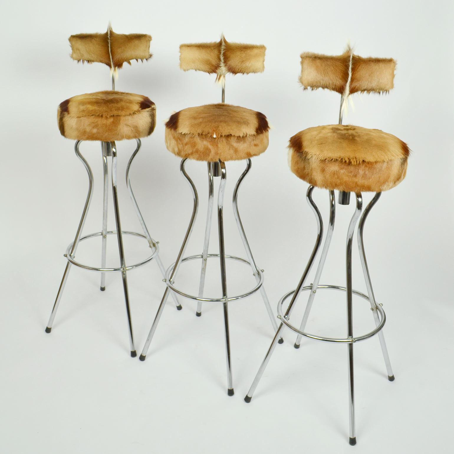 Set of three swivel bar stools with back rest in chrome, new upholstery in goatskin by Tambourin. The way they are upholstered they show the character of each skin to's optimum.